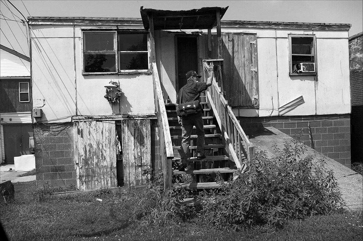 August 2017: Dennis rents an efficiency apartment for $250 a month. “It’s an old, old building. I mean, as long as the roof’s still standing, I got a place to sleep. Well, plaster’s falling off the walls, floor’s sinking, the ceiling’s sinking in. My refrigerator probably has been there for the last 50 years. It’s got rats, which I don’t mind. They don’t bother me. Cockroaches are often seen in the hallway in the daylight. Some residents refer to the place as “the slaughterhouse” because it’s rumored the building once housed a meat-processing business. The floor’s had a dip ever since I moved in. I told the manager the floor needed to be fixed. He assured me it would be fixed, but it never got fixed. Over two years it’s just gotten worse and worse.”Although Dennis points out issues with the building, he is grateful the manager has worked with him while he was in arrears on his rent. 