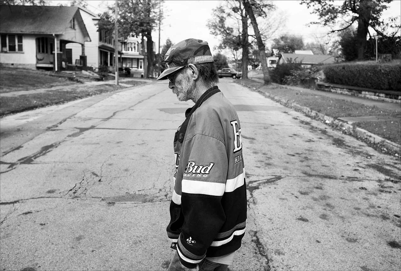 November 2017: Visibly thinner two months after his diagnosis of lung cancer, Dennis walks home from a doctor’s appointment. He weighed 145 pounds in September and now weighs 110 pounds. Dennis says the demolition work he’s done for years probably contributed to the cancer. “They do things illegal all the time.” Now Dennis has stopped working his demolition job, and says he’s too weak to walk Levi. “I’ve had no food for two days. I’m in pain. I can’t deal with this pain anymore today.”