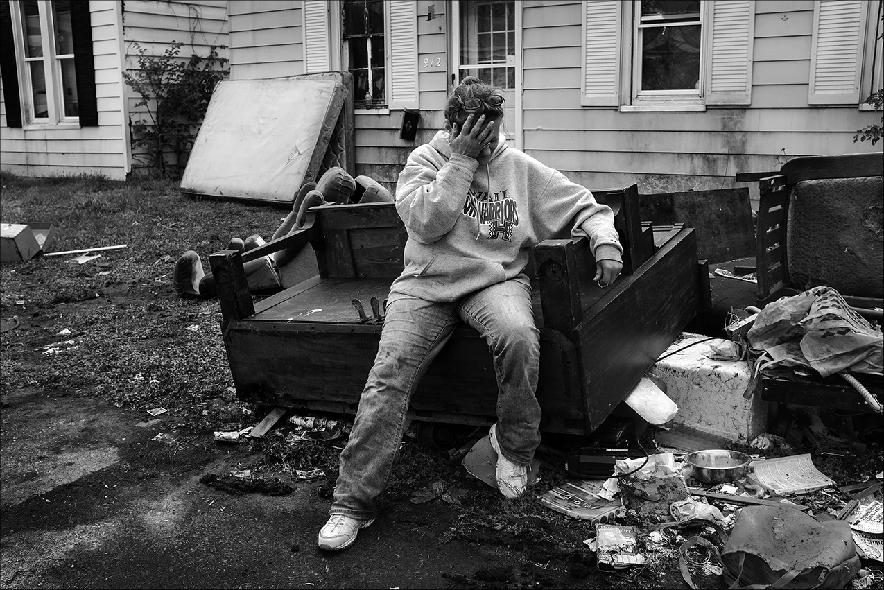 May 2017: Overcome with emotion, Elizabeth rests on her rain-soaked, antique piano, now a total loss. She said at age 36 she wanted to learn how to play piano and searched until she found one she could afford and took piano lessons. "I was saying goodbye to my old friend," she said.