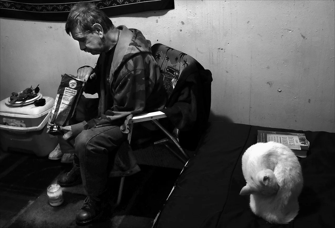 November 2016: James eats canned goods and potato chips for his Thanksgiving meal at “the slaughterhouse” where he rents a small room for $100 a month. The small room has a twin bed, a lawn chair and a cooler for a refrigerator. He shares two common…