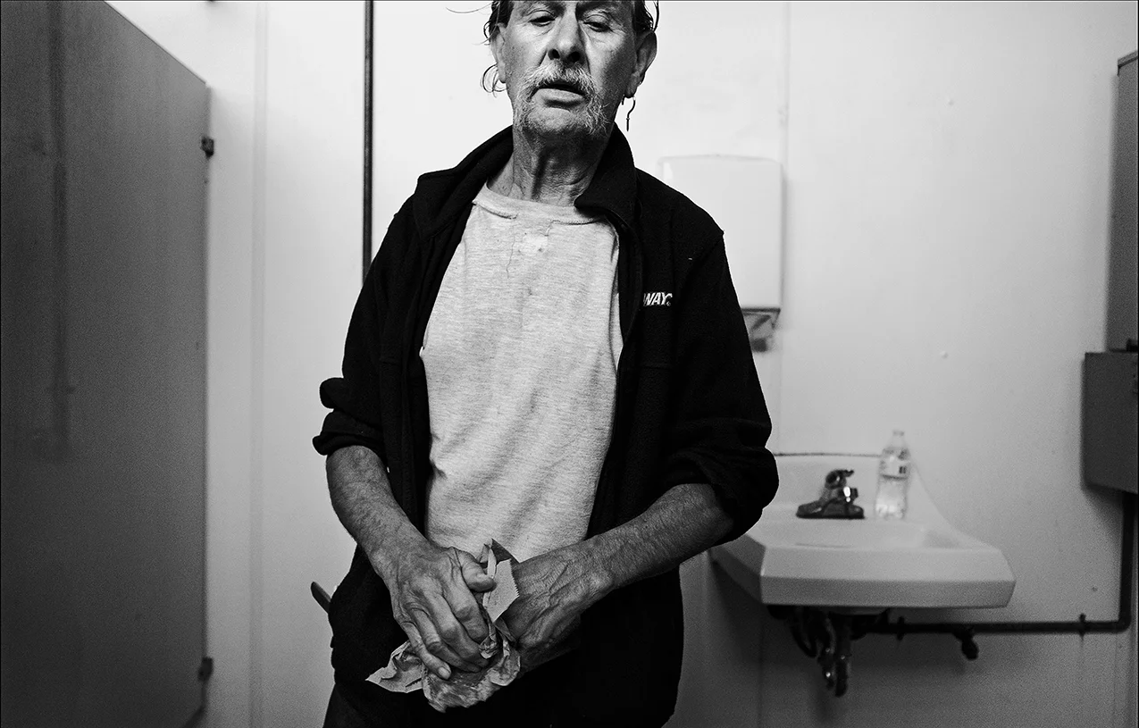 May 2017: James washes up in a public restroom. “I know what it’s like to be hungry and freezing.”