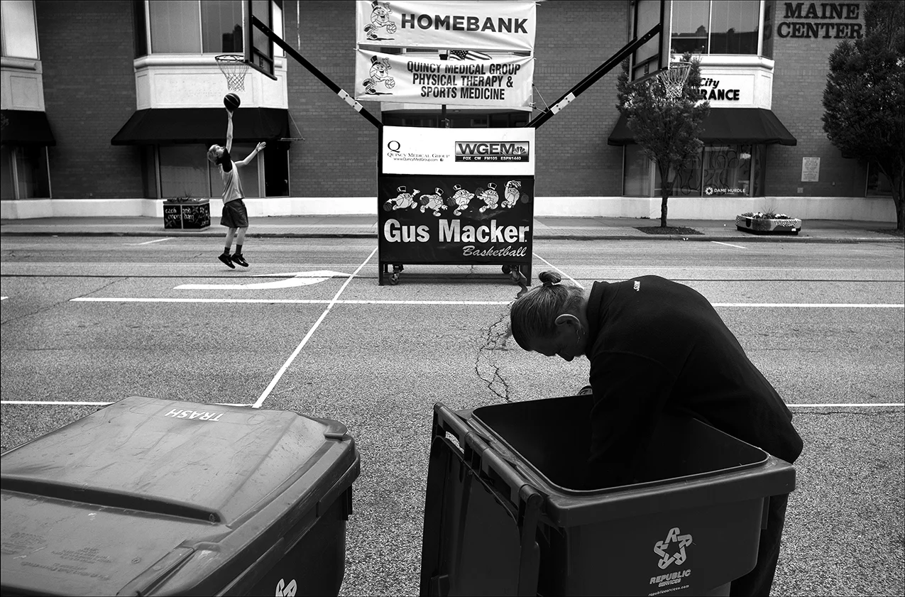 May 2017: During the week of the Gus Macker Tournament in Quincy, James sifts through garbage looking for an extra plastic bag to replace one that is torn. James says once a Quincy police officer was going to take him to jail while he was getting food out of a dumpster, but when another officer intervened, he was only given a ticket for having a hole in the backside of his pants. He says he has to go to court over that.