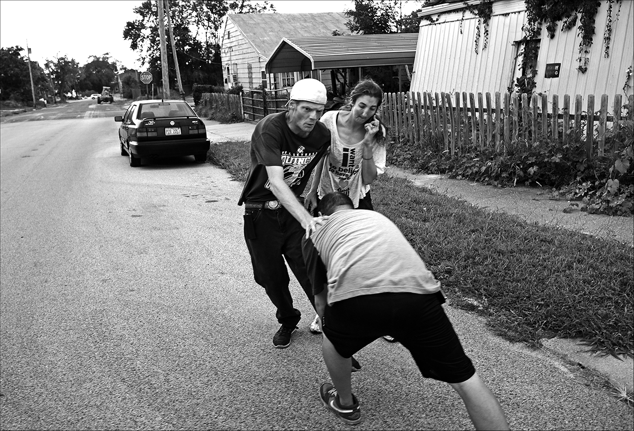 August 2016: Walking back from moving his meager belongings from one spot to a drier spot in the anticipation of rain, friends try to help straighten-out James’ dislocated knee. James says, “no matter what situation you’re facing, its always best to keep your eyes fixed ahead towards the brighter light and it will always get better.” That’s what this whole thing is about, helping each other.”