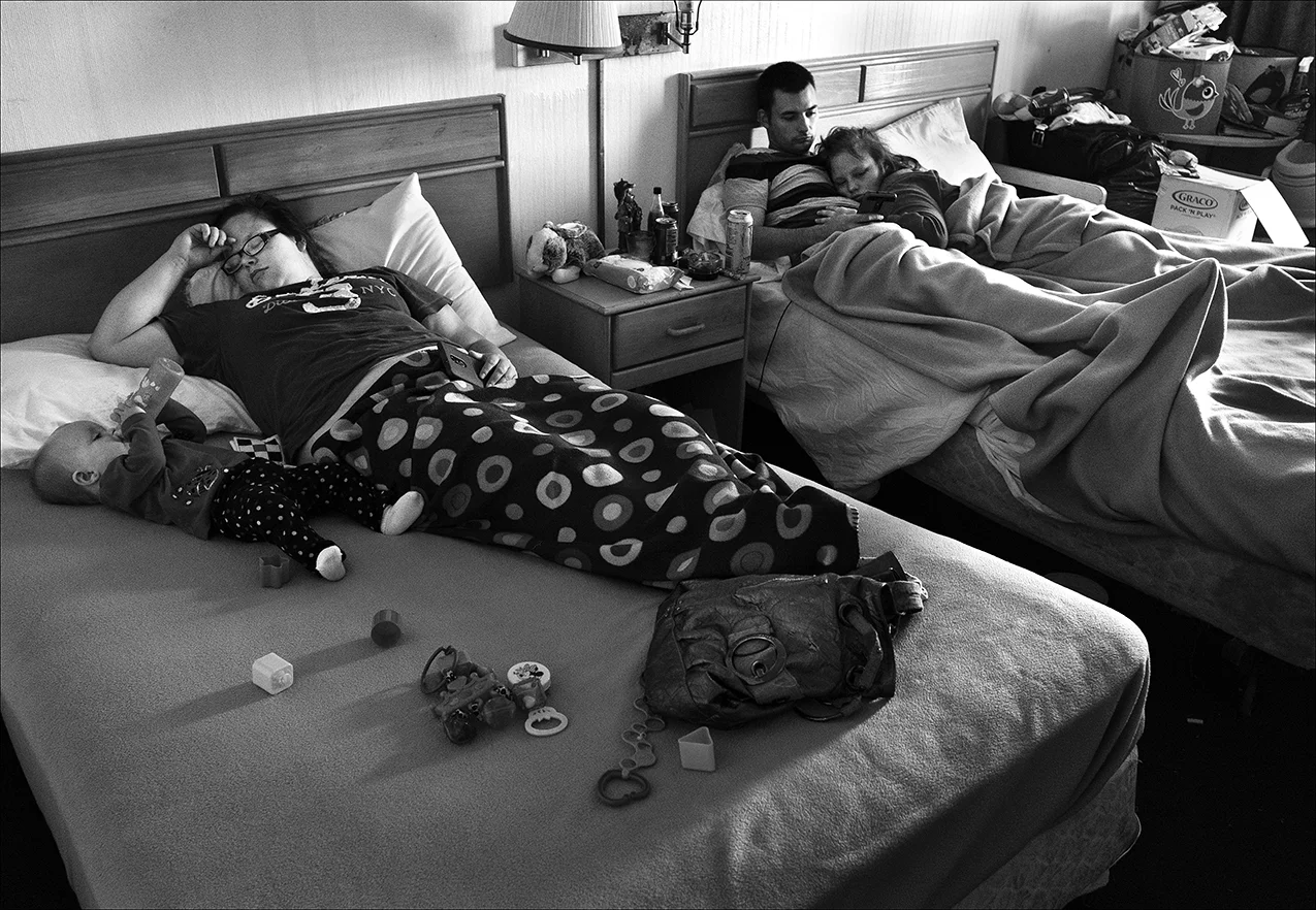 June 2017: Homeless, Josh and Brooke are staying with Brooke’s sister and her baby in the Welcome Inn. “Me and my wife was living with my mom, and she got upset over hot dogs. She got mad because somebody ate all the hotdogs, and kicked us out. So now we’re living on the street with my dog and I’m on disability SSI. And I don’t have nowhere else to go. My food stamp card’s $188 and my SSI is only $735, and that’s really not enough to live off of, with the rent and stuff around here. And some places don’t let you have your dog, and my dog’s been with me for four years. He’s like my own son. He’s protected me. I saved him from abuse and neglect, just like I was when I was a child, being abused and neglected.”