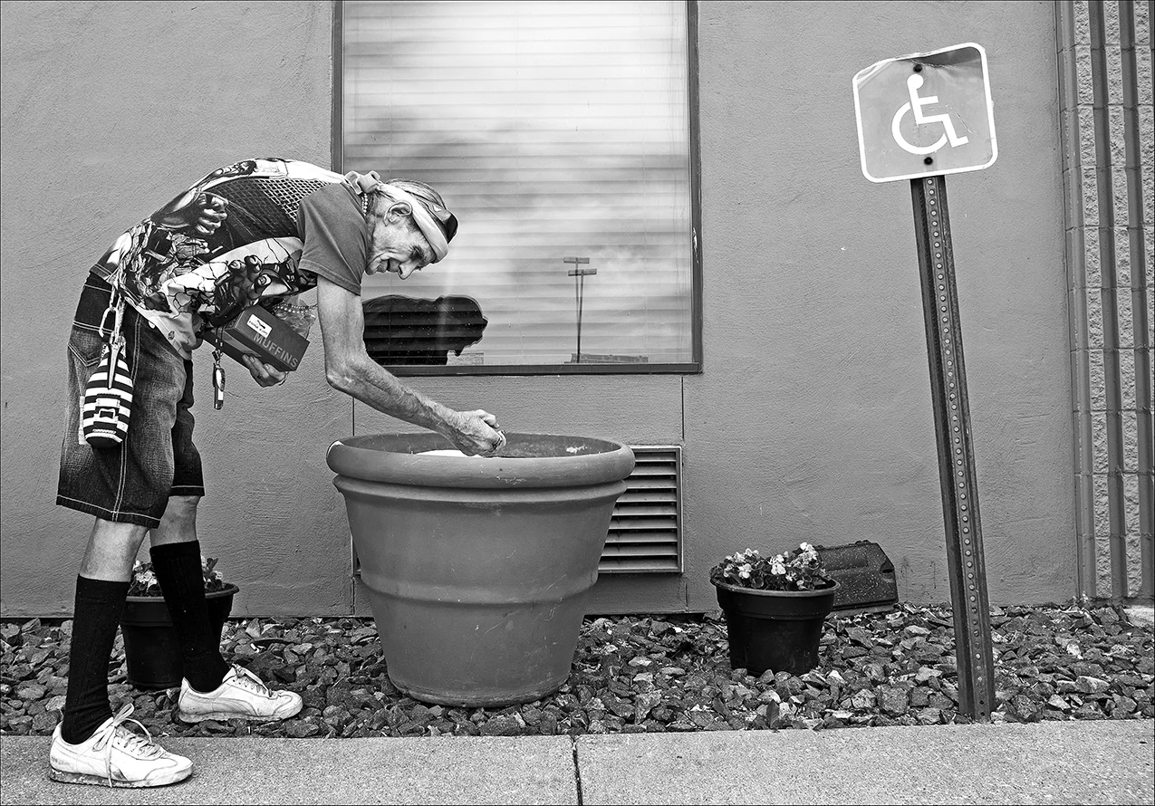 June 2017: Homeless and out of money, Walter finds a bonanza of cigarette butts while walking by a local motel smoking area.