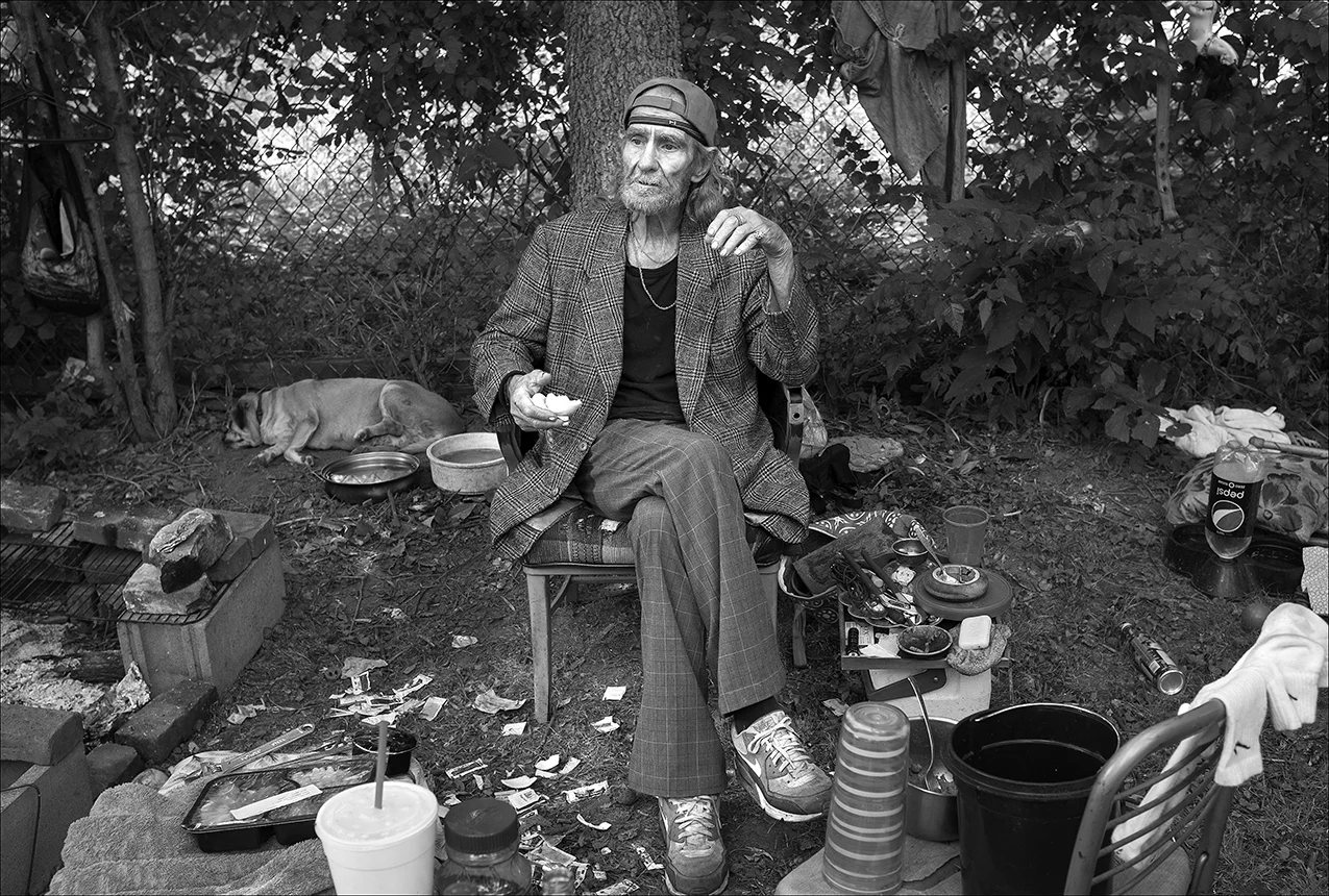 A ugust 2017: Walter relaxes in the backyard of the house he rented on Quincy’s north side after eight weeks of homelessness. Walter says he’s paying $350 a month rent and another $50 a month to use the washer and dryer his landlady left in the house. There’s no heat or electricity because the landlady’s son actually removed the utilities meter. Waiting for the meter to be replaced, Walter is living part-time in the yard, where he cooks on an open fire. “I’ve been living in the backyard for a month and a half making cowboy coffee, you know what that is, where you can stand a spoon up in it? I got a pretty good setup here in my backyard, I got me a barbecue pit that would hold at least a half of a cow, maybe the full damn cow. I built it myself out of cinder blocks, bricks and grates that a man gave me off a barbecue he had. Walter did some work for a man who paid him with three lawn mowers, three barbecue grills, and three air conditioners, all of which Walter planned to repair and sell. Then, Walter says, people began stealing from him. “There was a Craftsman, self-propelled, damn good lawnmower. I just needed to put some rear wheels on it. And there was a ‘green machine’ … You know what I’m talking about when I say ‘green machine’? Weed Eater brand. I went after my last lawnmower, I already had two here, I think. While I was going after the third one, someone come in, took the two I already had here, plus a weed eater that I paid $100 for. It makes me angry after buying something and having it come up missing a week later. I finally got a phone after six months without one and it came up missing too. They’re in a pawn shop by now.” A few months later, Walter’s backpack with all of his personal records is stolen. He must replace everything — his driver’s license, Social Security card, his SNAP card. It takes weeks to replace the identification cards he needs to reapply for his SNAP card. 