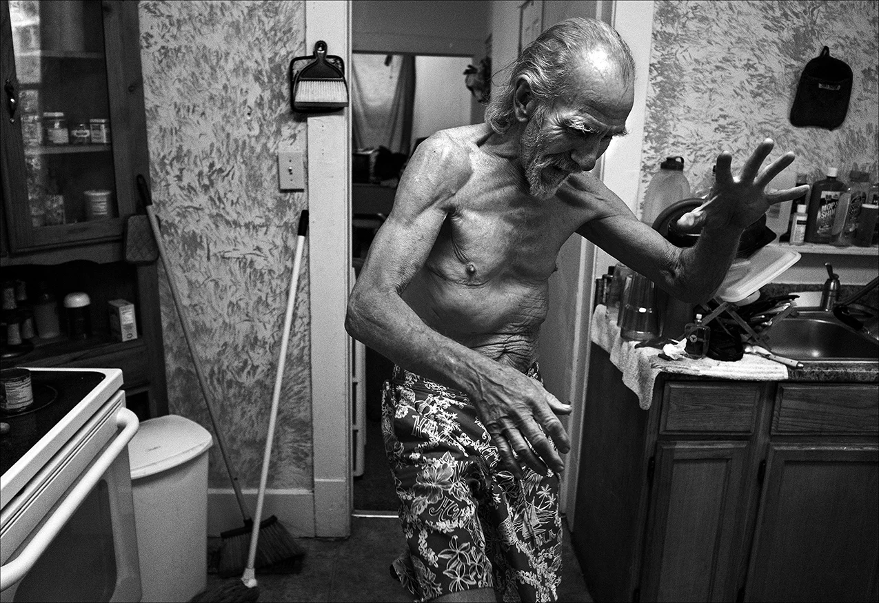 April 2017: Walter, in his kitchen, prepares to launch a “karate kick” to demonstrate his physical prowess at age 72.