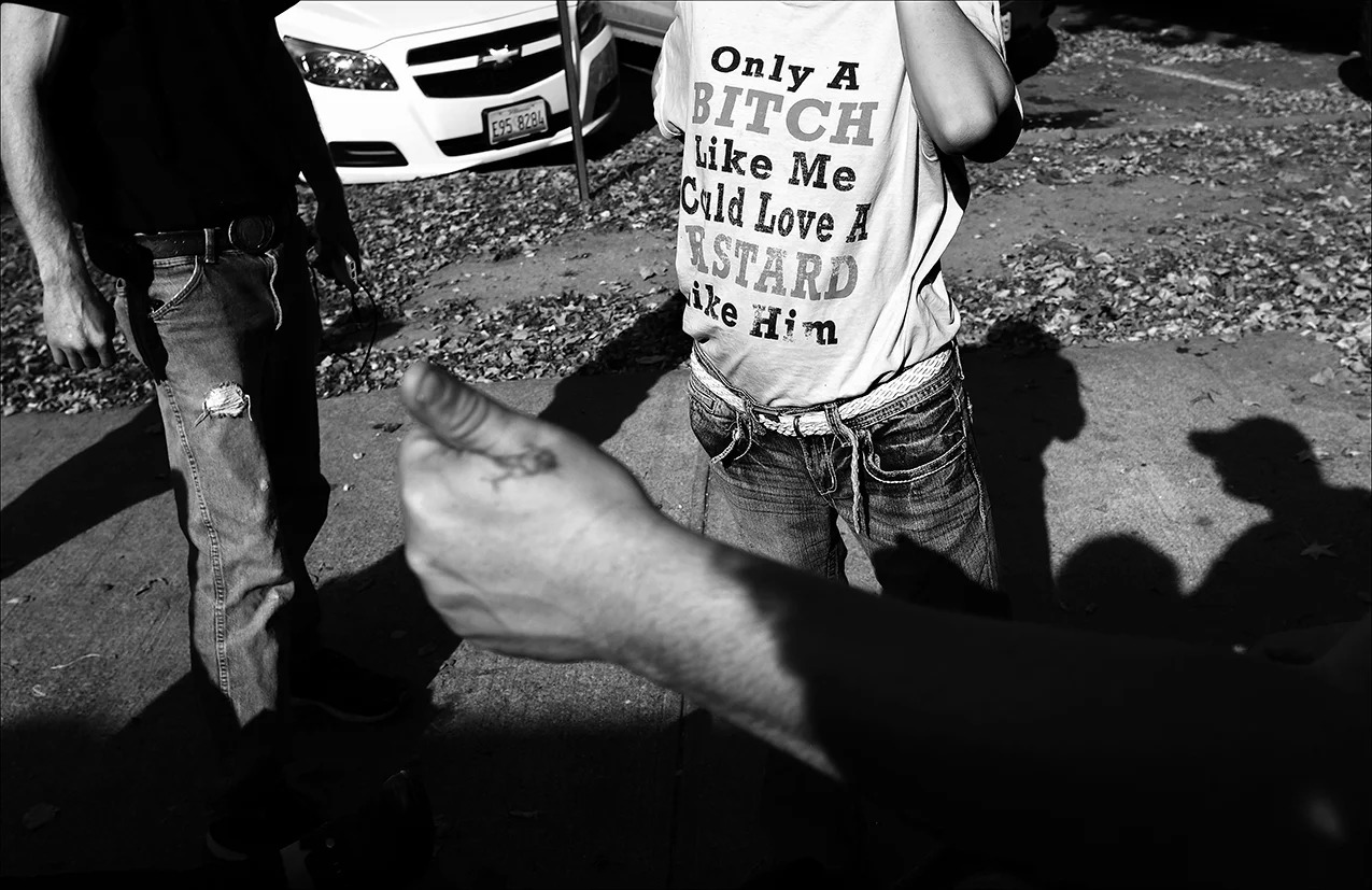 September 2017: On a warm afternoon, James hangs out with friends at Washington Park, while waiting to meet a friend he met online. He will sell his phone for some cash, so he'll have some spending money until the first of the month.