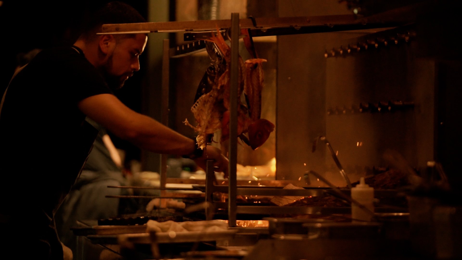 Chef cooking meat on a grill