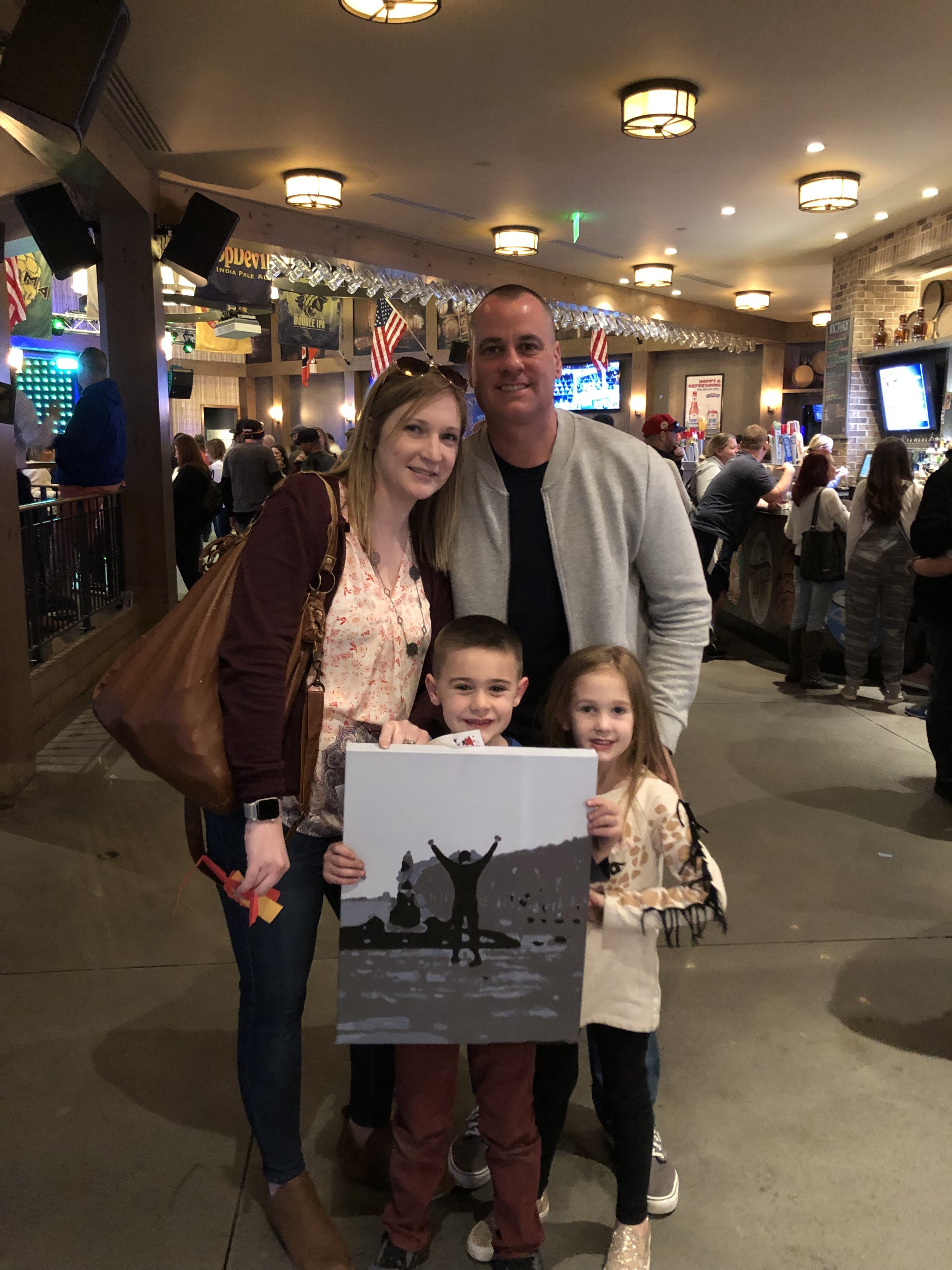 The Malone family won a custom Rocky painting by Kate Conway