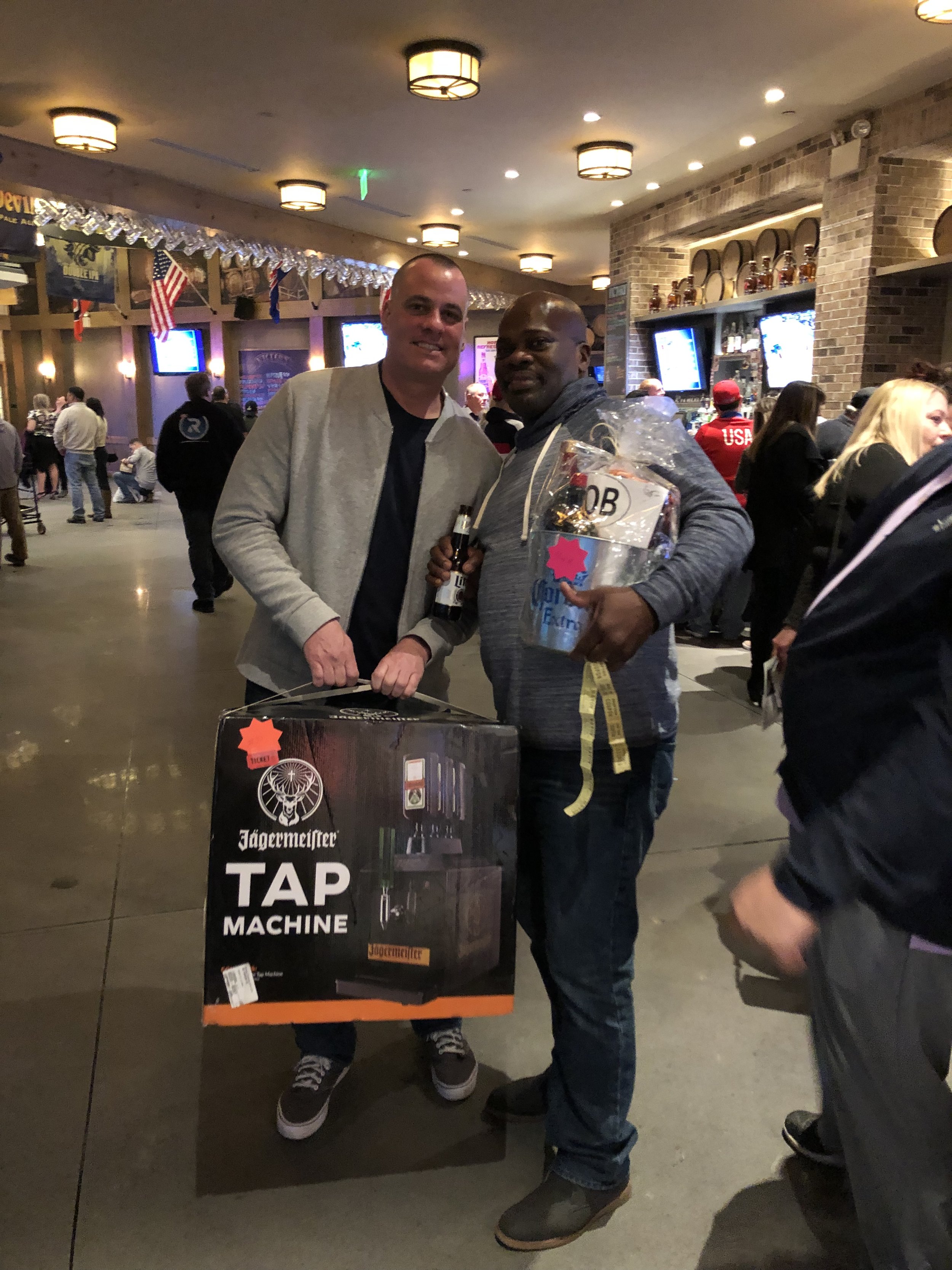 Liquor basket winner Donovan with double winner Jerry Malone who also took home a Jagermeister tap machine.