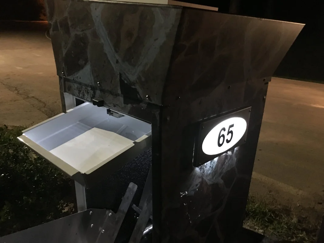this unit, pictured at night, includes the added mailbox accessory. mail and parcels can be retrieved from the rear and all deliveries are made to the front of the mailbox sentinel. parcels go in the bottom and mail goes in the top keeping deliveries separate and secure.