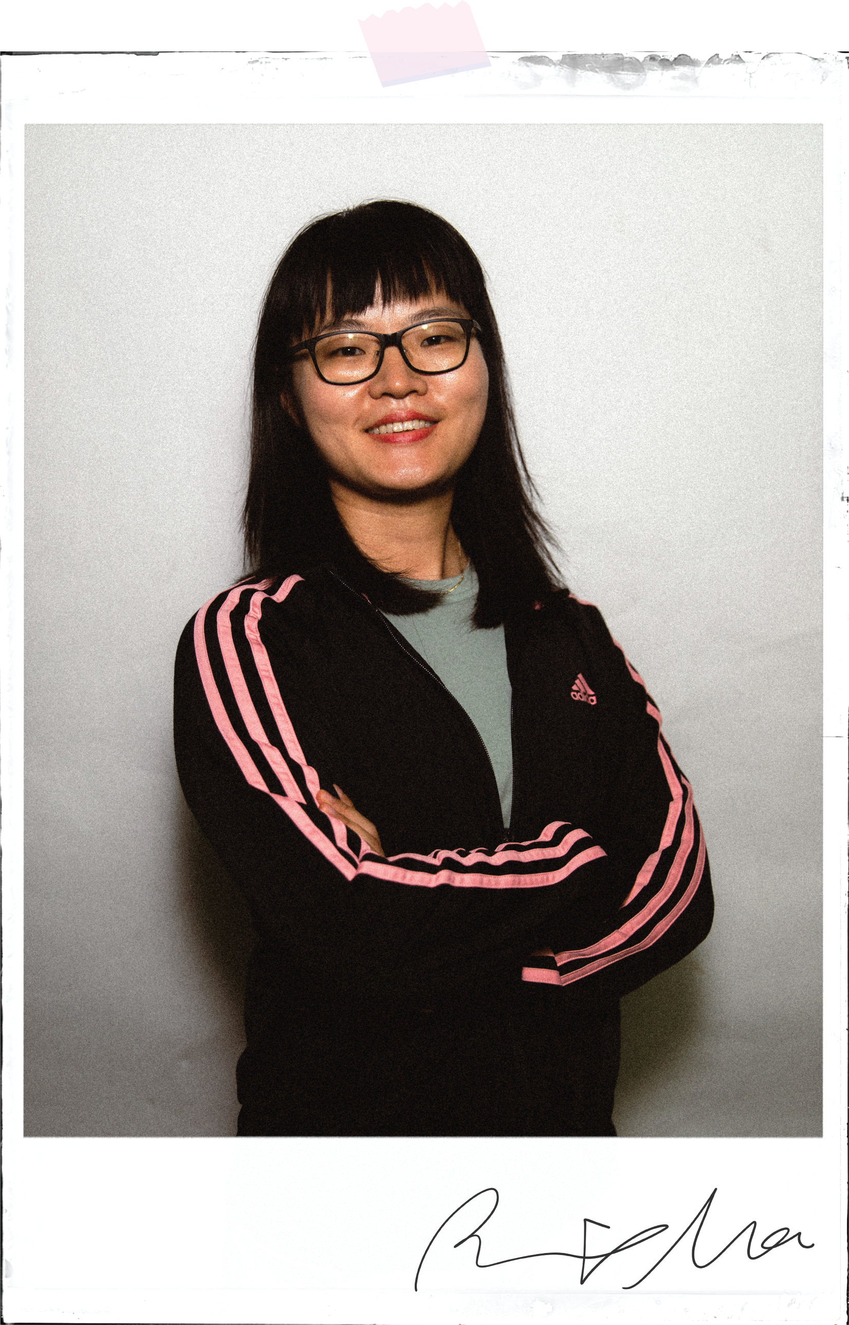 Rachel's poloroid portrait taped to the background with her signature underneath