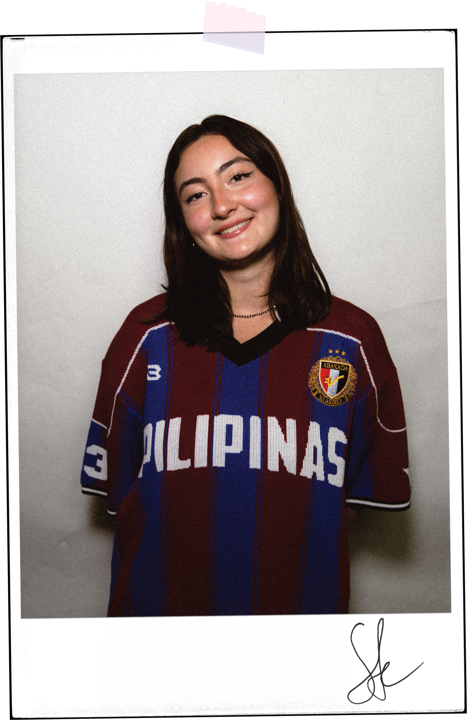 Sophia's poloroid portrait taped to the background with her signature underneath