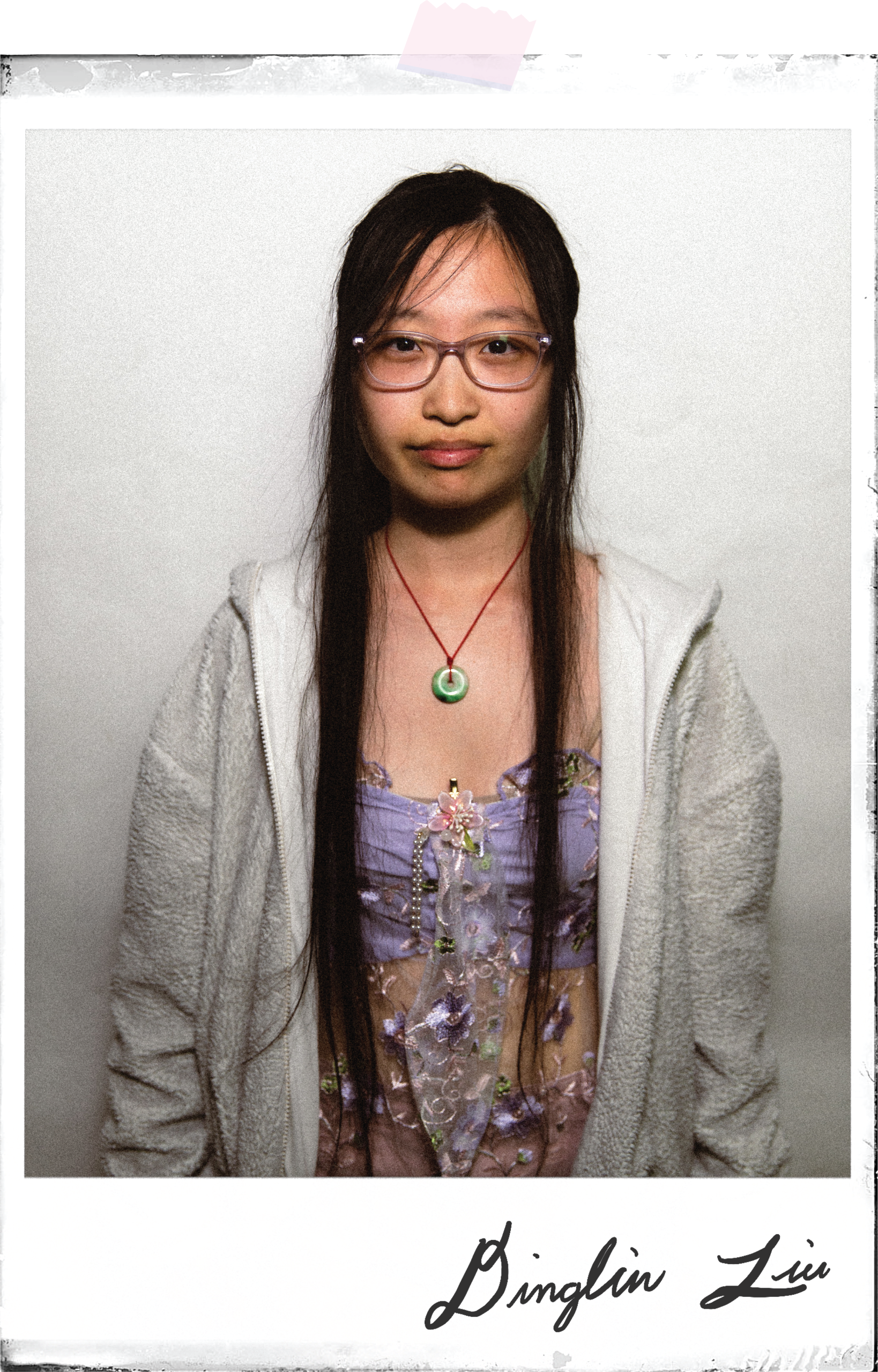 Lin's poloroid portrait taped to the background with her signature underneath