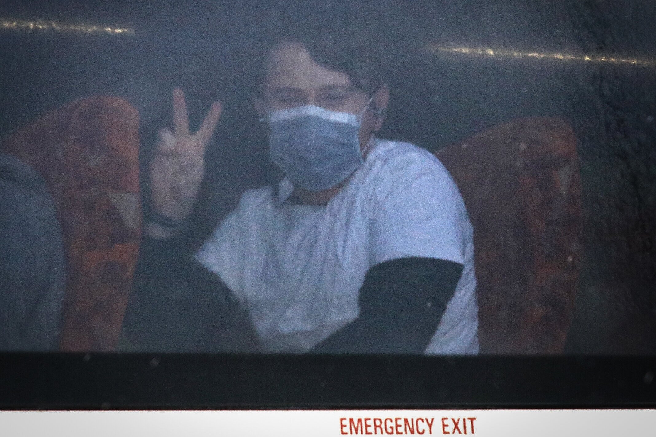  A passenger gives a peace sign as coaches carrying Coronavirus evacuees arrive at Kents Hill Park Training and Conference Centre, in Milton Keynes, after being repatriated to the UK from the coronavirus-hit city of Wuhan in China. Picture by: Aaron 