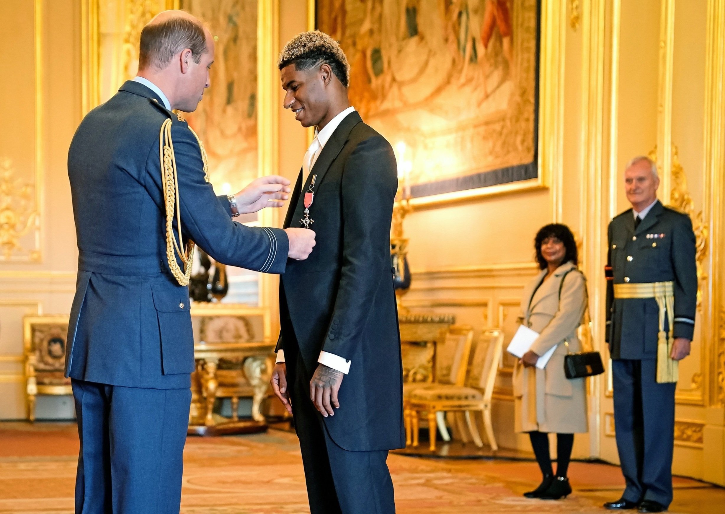  Footballer Marcus Rashford is made an MBE (Member of the Order of the British Empire) for services to vulnerable children in the UK during the coronavirus (COVID-19) pandemic, by the Duke of Cambridge as his mother, Melanie Rashford watches on durin