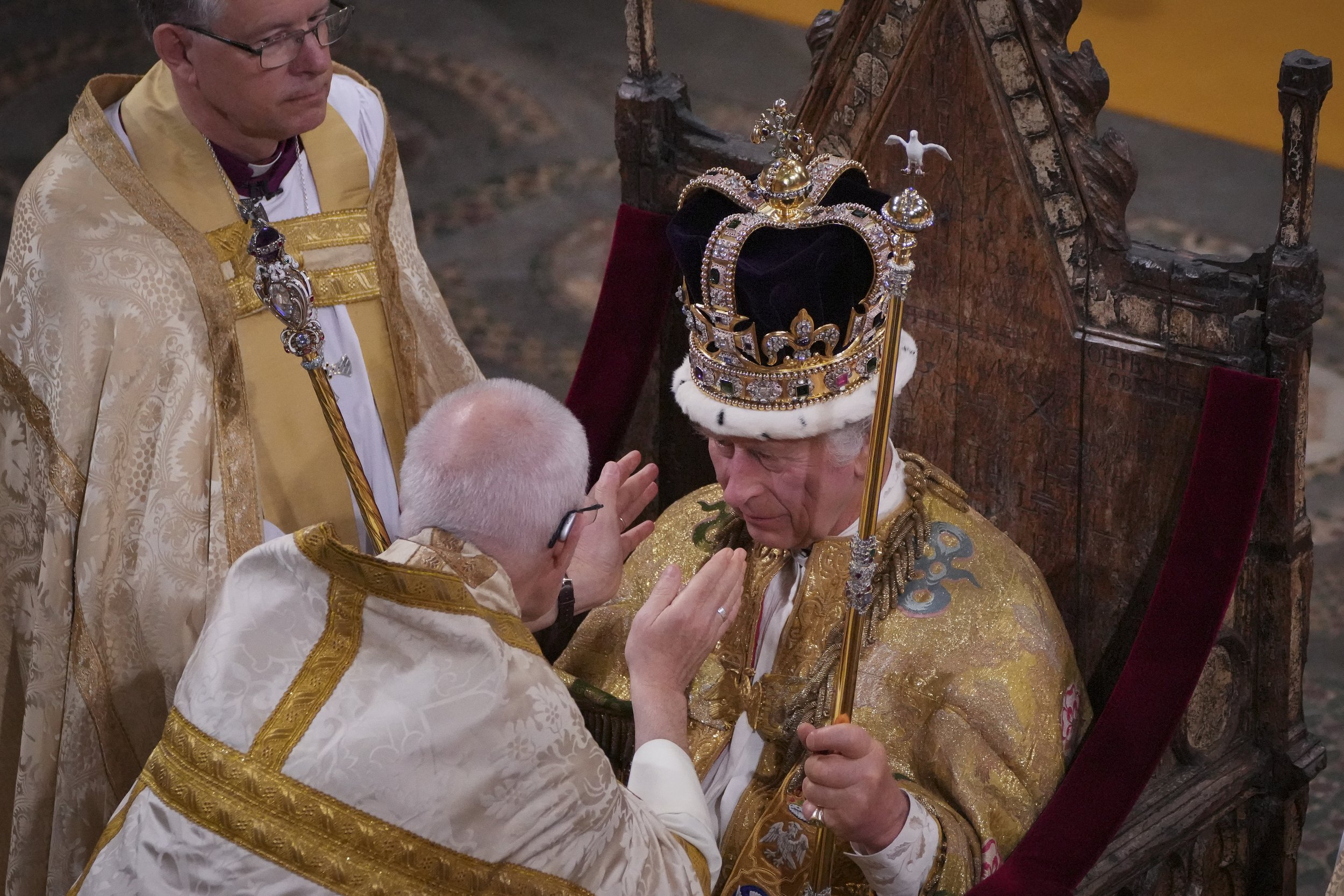  King Charles III, seated in St Edward's Chair, also known as the Coronation Chair, is crowned with St Edward's Crown by The Archbishop of Canterbury the Most Reverend Justin Welby during his coronation ceremony in Westminster Abbey, London. The King