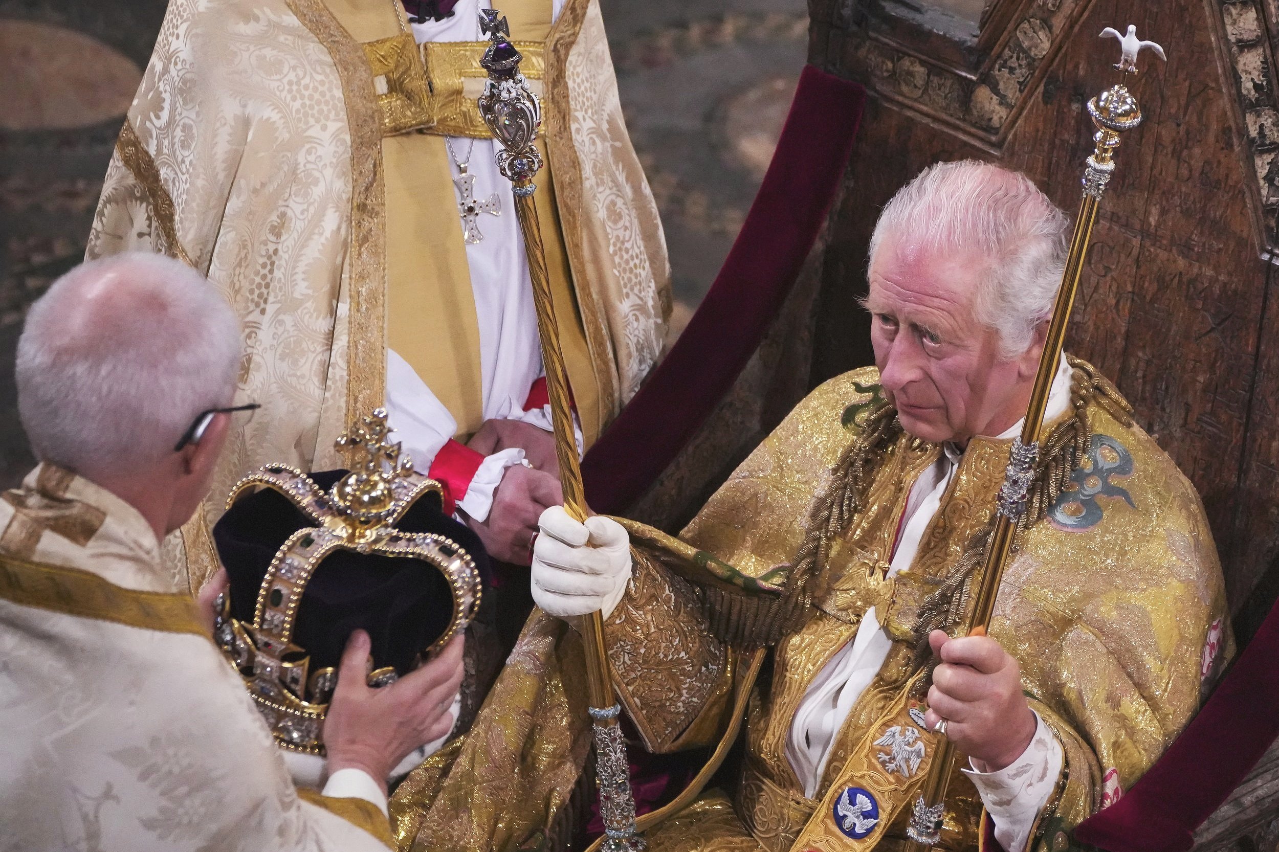  King Charles III, seated in St Edward's Chair, also known as the Coronation Chair, before being crowned with St Edward's Crown by The Archbishop of Canterbury the Most Reverend Justin Welby during his coronation ceremony in Westminster Abbey, London