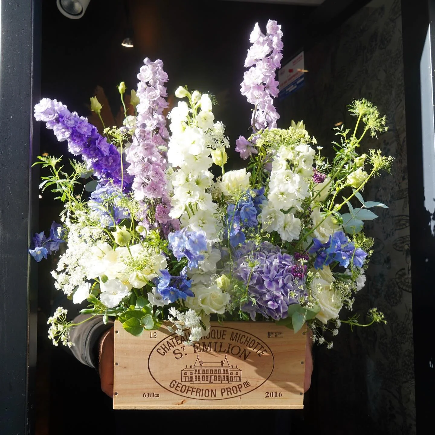 White and blue arrangement in a wine box