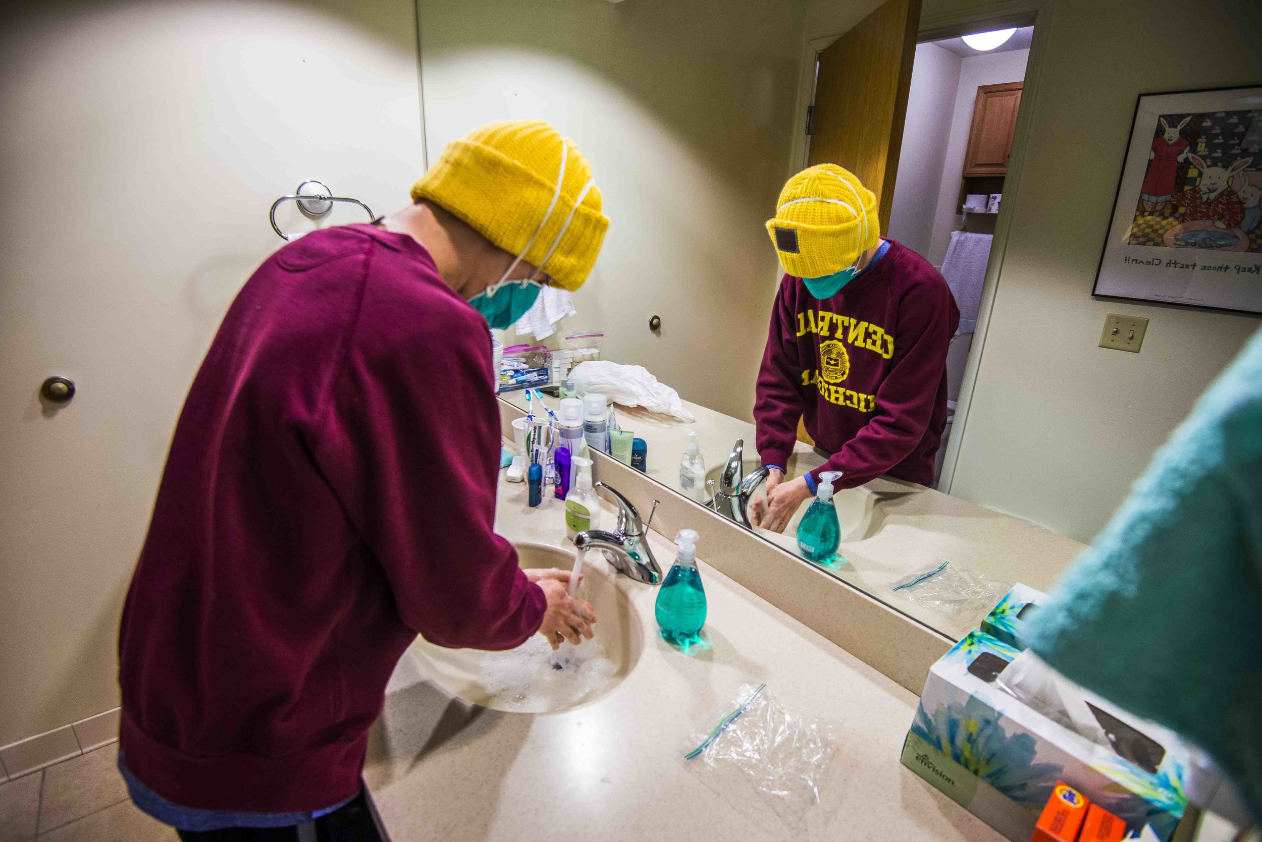  Tanner washes his hands in his room at the Ronald McDonald House, March 5. Tanner is required to wear a mask whenever he is outside or in contact with people other than his mother.&nbsp; 