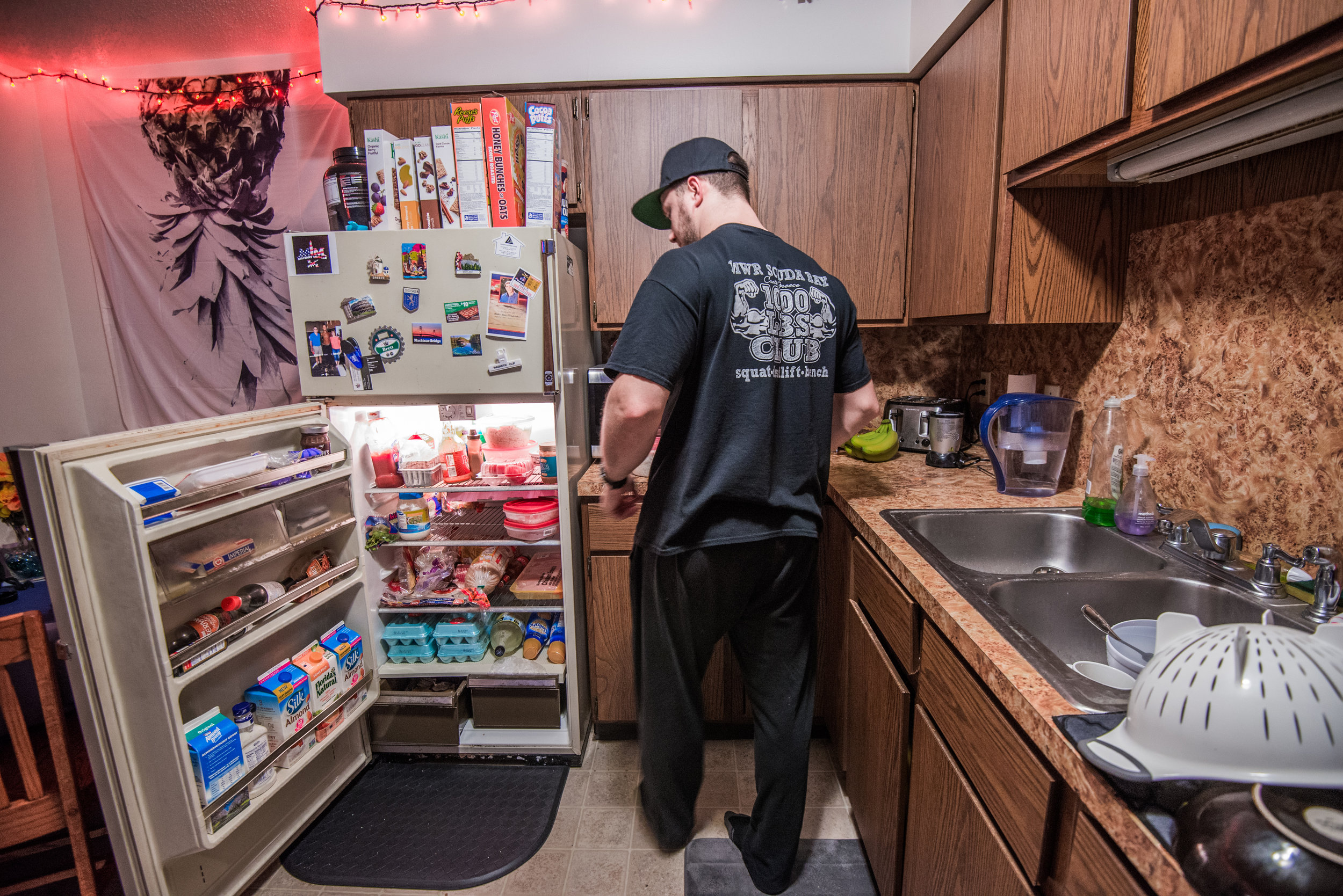  Brett prepares chicken and rice in the kitchen of his home, Oct. 10 in Mount Pleasant, Michigan. "We're not super concerned with eating too much as long as we're not eating too little," Brett said. 