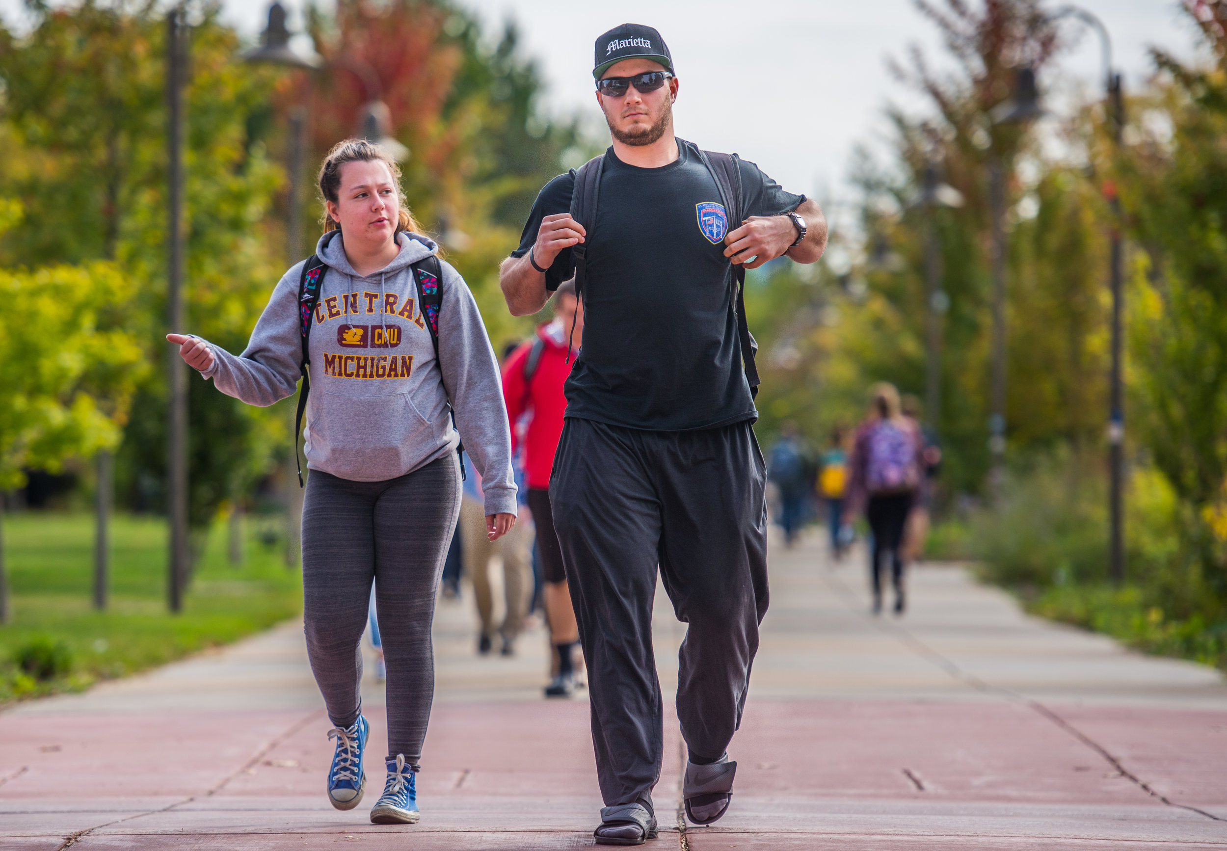  Brett and Alexis walk through the campus of Central Michigan University, Oct. 10 in Mount Pleasant, Michigan. They're both seniors and plan to attend graduate school after this year. Brett majors in Social and Criminal Justice and Alexis majors in P