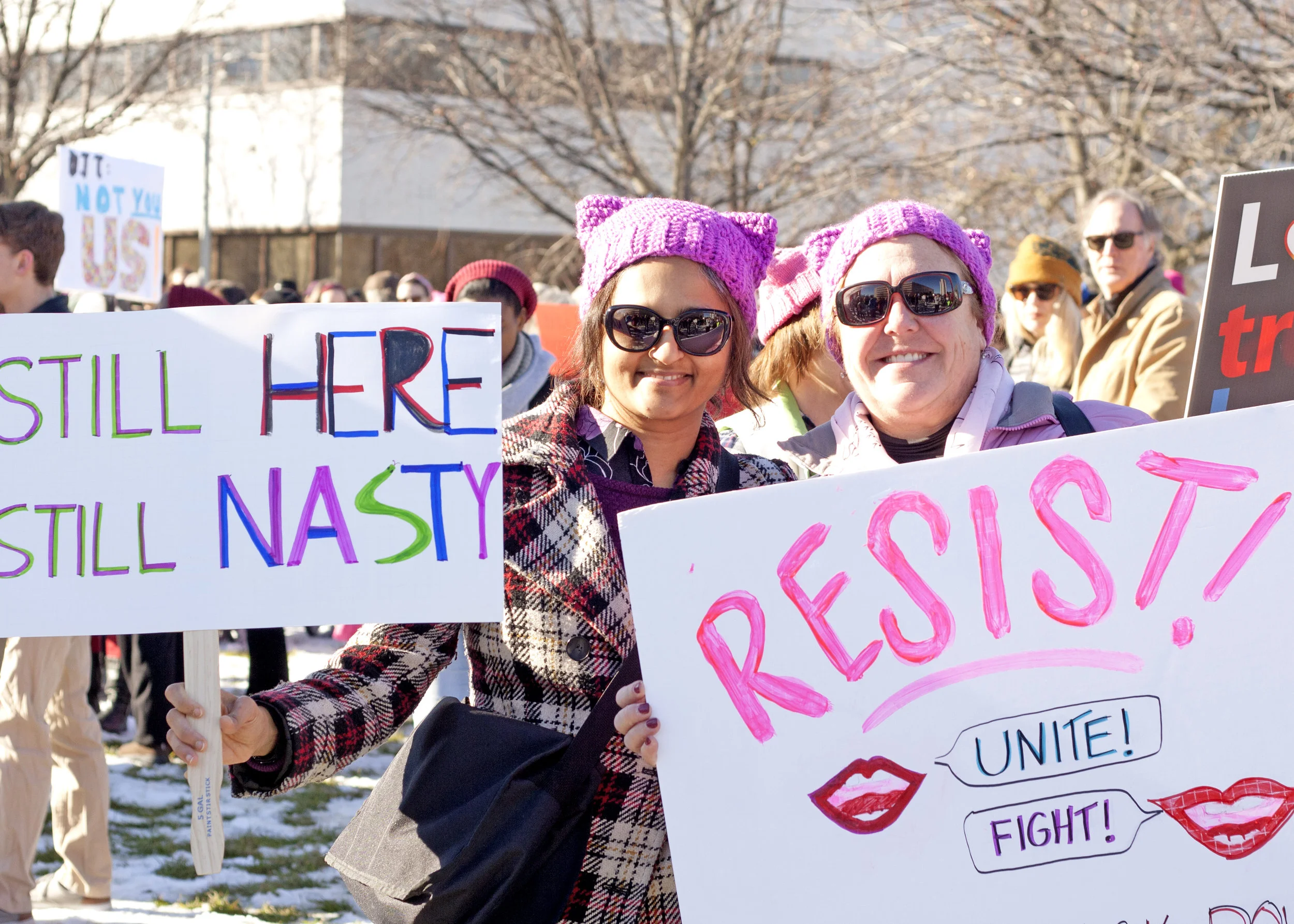 Maria and Sanjy hold signs at the Rally on Raleigh in Halifax Mall on Jan. 20.