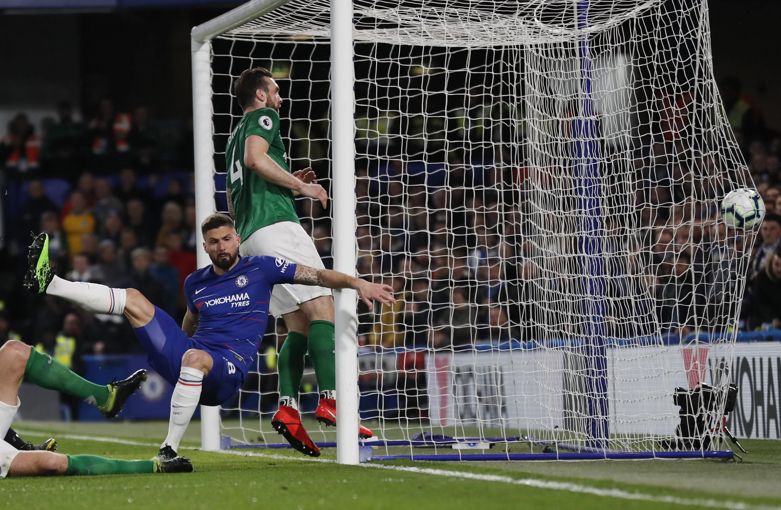 Chelsea's Olivier Giroud, left, falls after scoring his sides first goal past Brighton's Shane Duffy, right, during the English Premier League soccer match between Chelsea and Brighton &amp;amp; Hove Albion at Stamford Bridge stadium in London, Wedn…