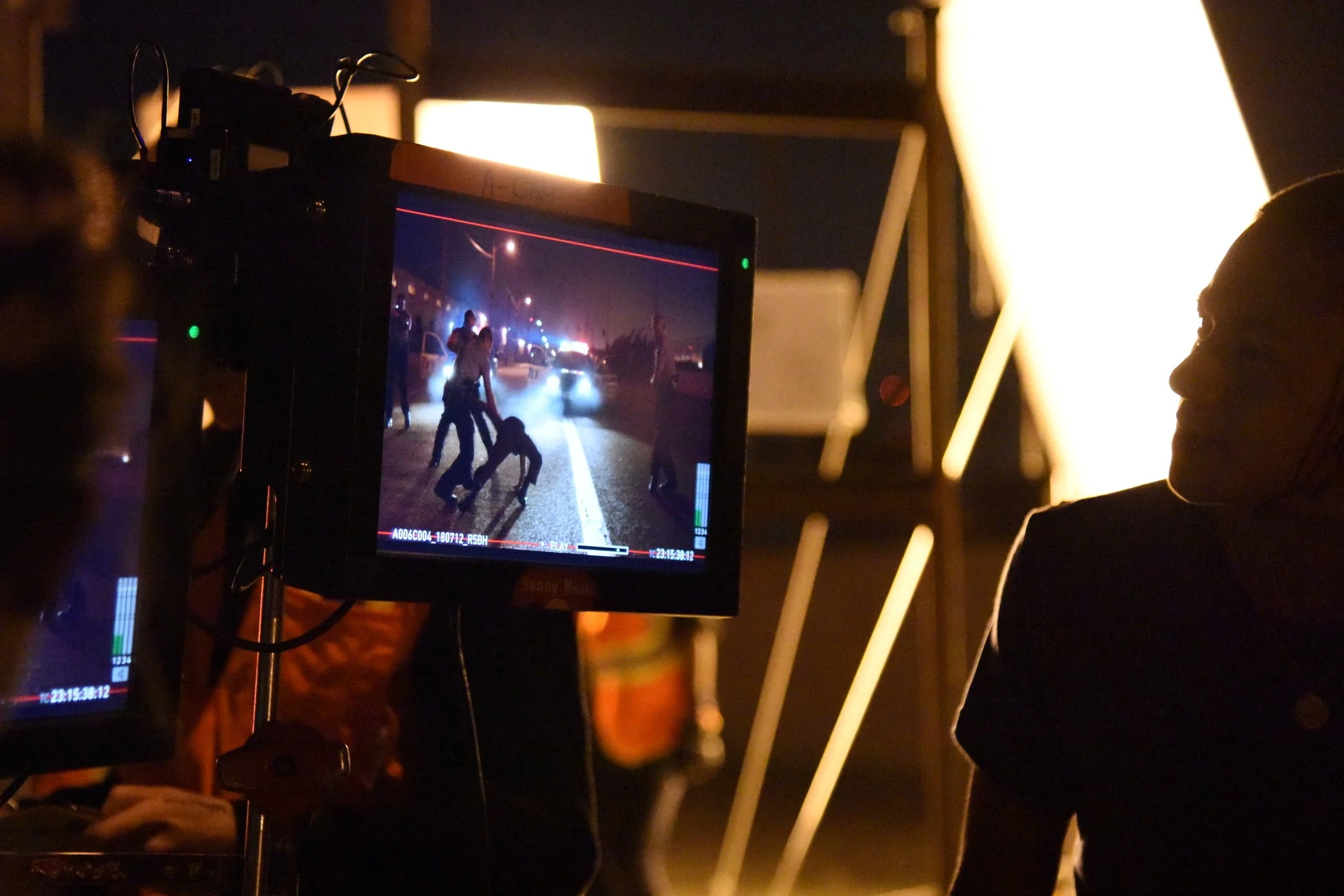 Actor Brandon Soo Hoo sneaks behind the monitors to watch playback.
