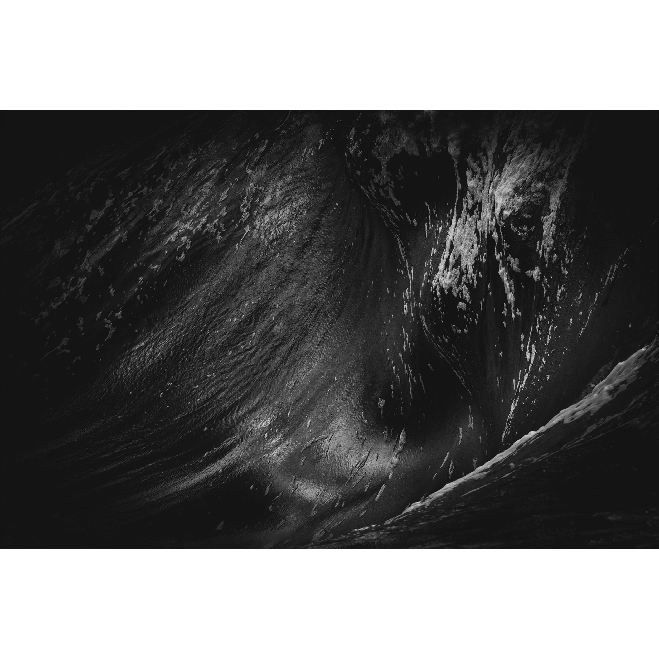Reverie – Limited Edition black and white seascape by Tal Lemmens. A powerful wave breaks over reef in deep shadow. Fine art print, 1 of 10.