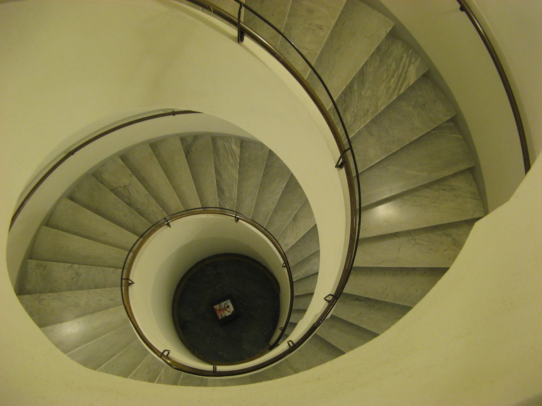 Table at the bottom of a spiral staircase. Hotel Sant'Elena, Venice, Italy.