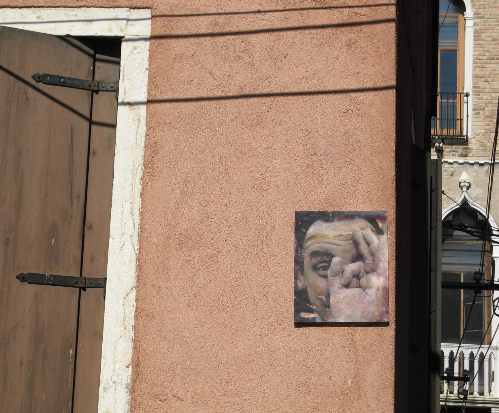 Salvador Dali looking at us. Image on building in Venice, Italy.
