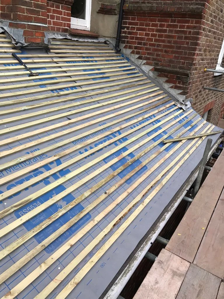 Treated battens installed over new roofing membrane on a pitched roof