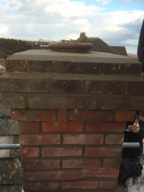 Repaired and repointed chimney stack with renewed flaunching near the Brighton coast