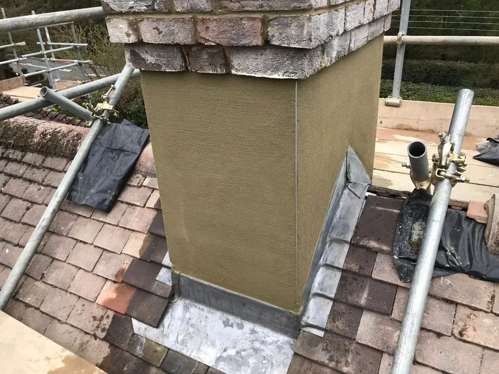 Rendered chimney with completed lead apron, stepped flashing and roof tiles