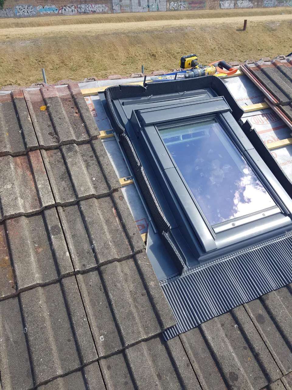 Bespoke Roofing roof-window flashing installation in progress on a tiled Sussex roof