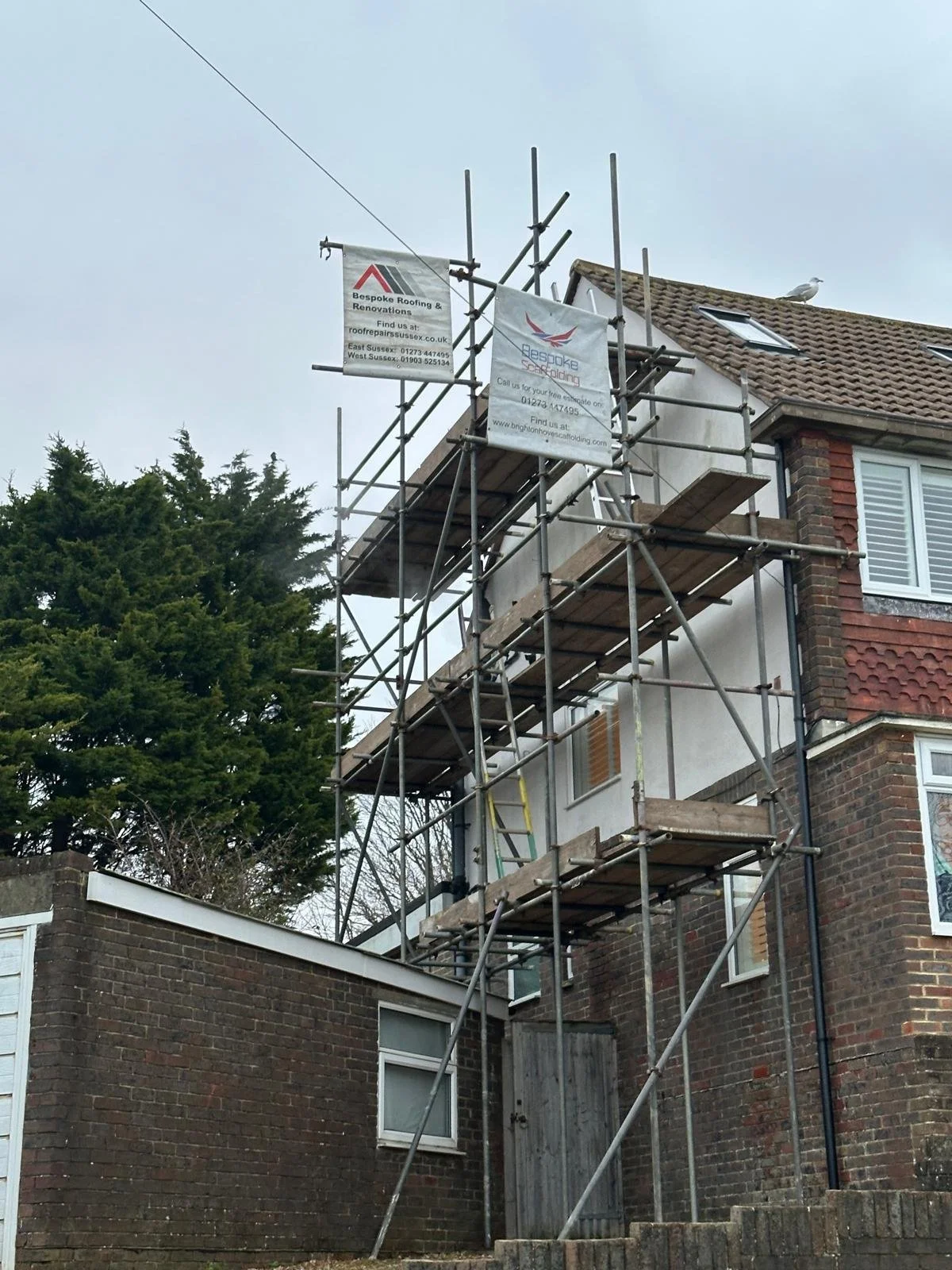 Scaffolded tiled roof undergoing repairs in West Sussex