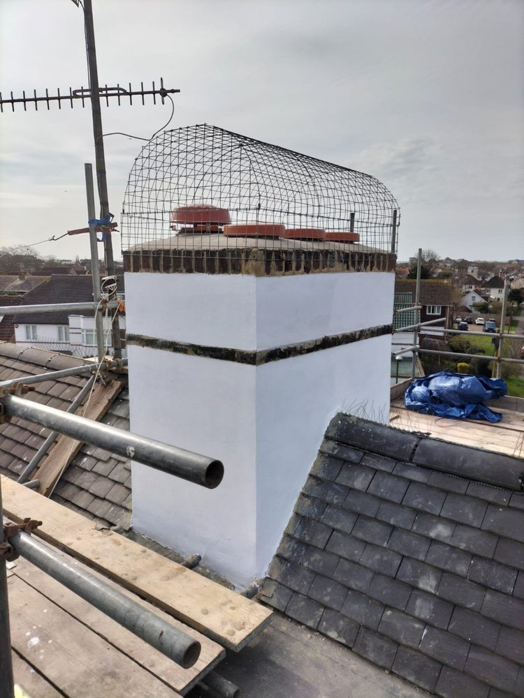 Completed rendered chimney stack with finished flaunching and protective cage