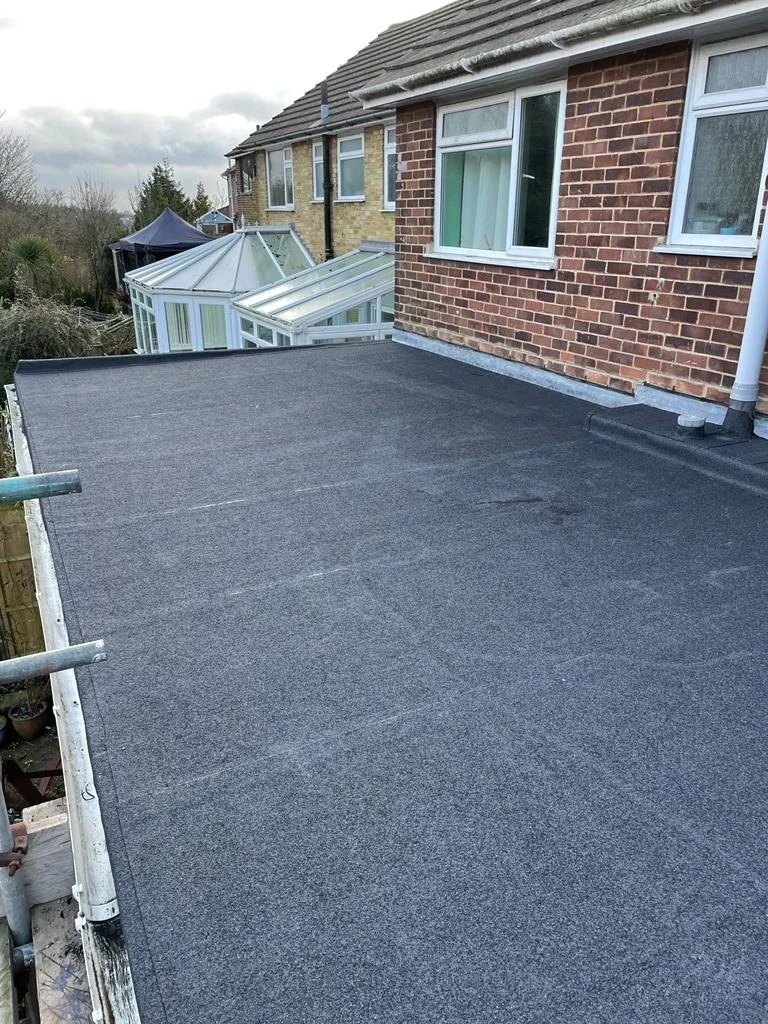 New flat-roof membrane dressed into a brick wall abutment