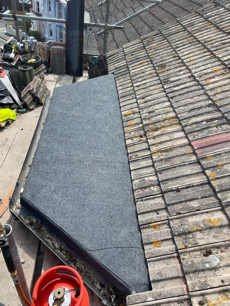 Mineral-finished flat roof adjoining existing roof tiles