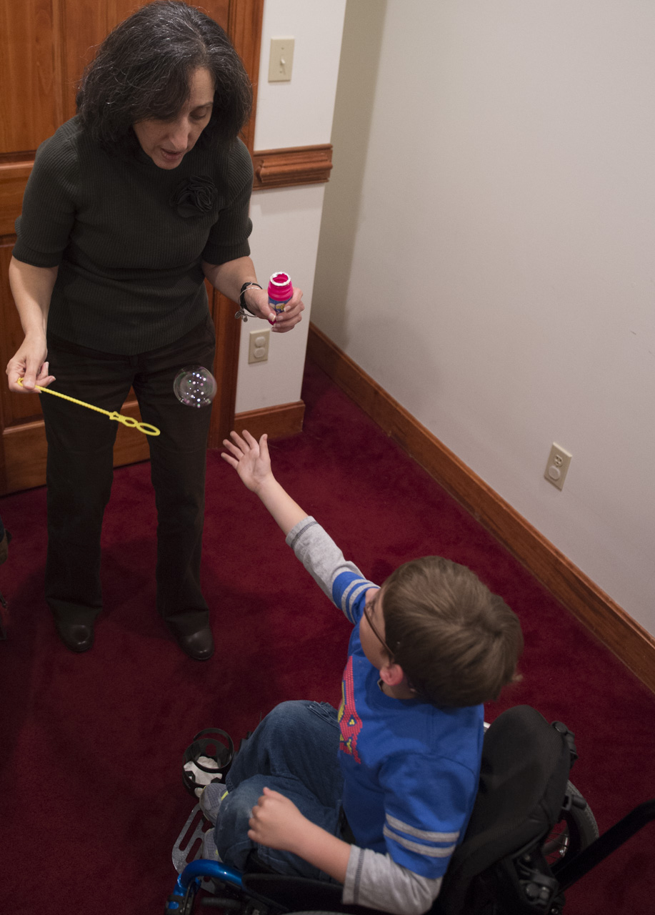  Josiah plays with bubbles after trying to blow bubbles with his speech therapist Diane Epling. “This is a treat for him,” said Diane. “He tries to blow the bubble to properly make words and then we play with them later to make it more fun and seem l