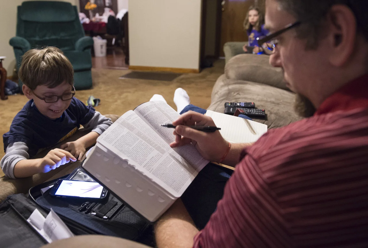  Josiah and Mary try to get their dad’s attention in Charleston, W.Va. while Jim, an associate pastor in his church, prepares the sermon for the next morning service. 