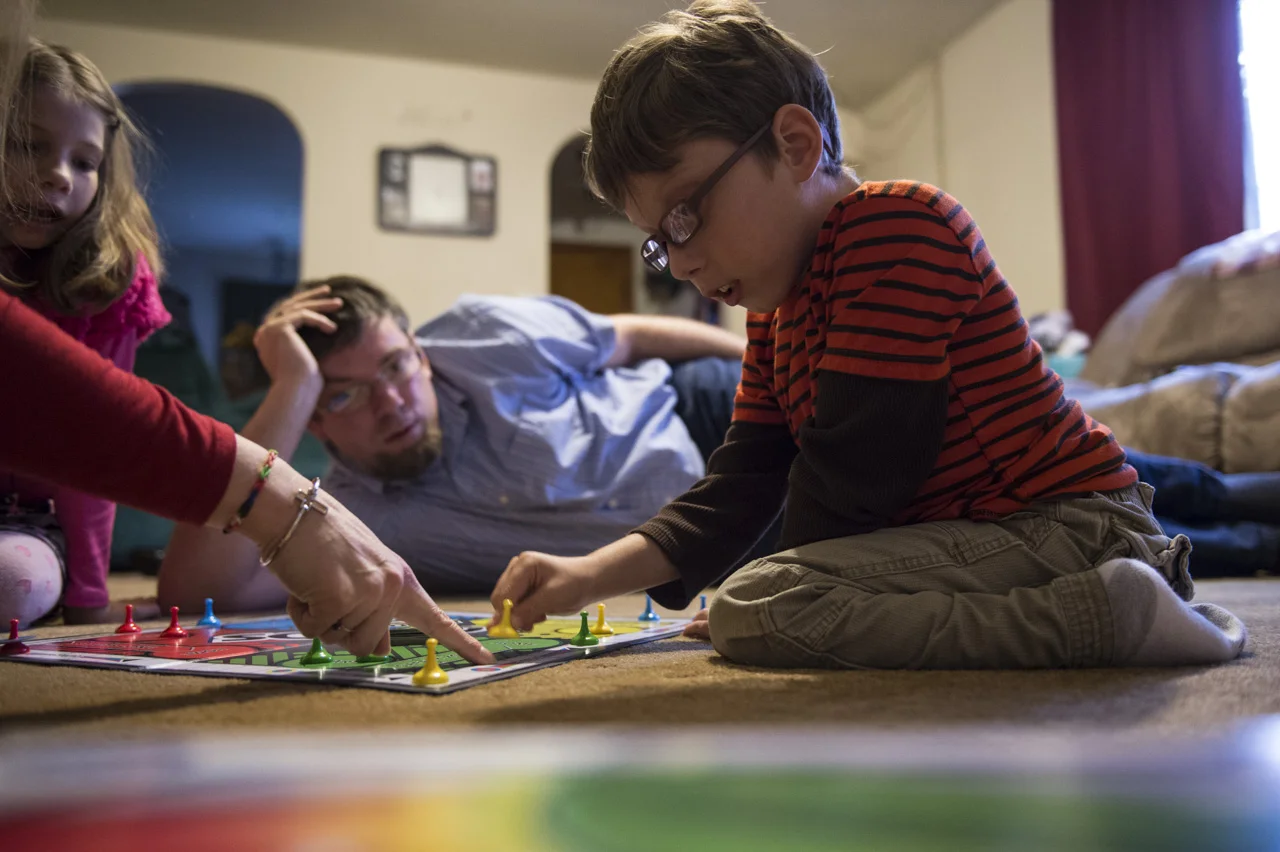  Crystal helps Josiah count out his moves during a family game of Sorry. “Family time on Sunday is very important,” said Mr. Fershee. “We try and play board games or do something interactive.” 
