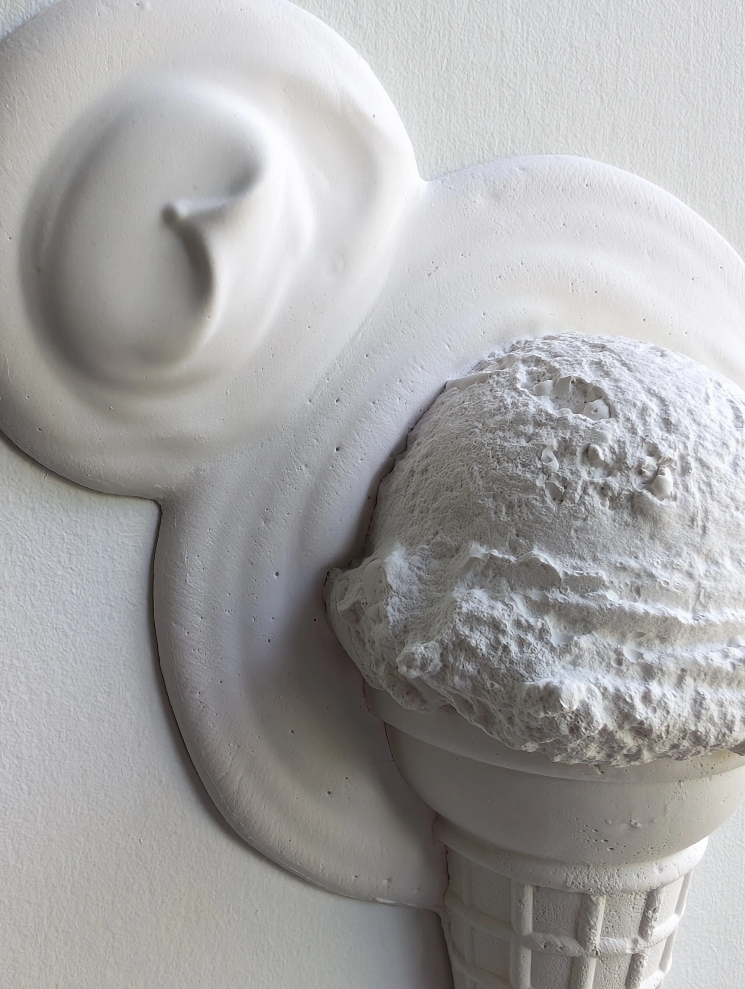 Detailed texture and shadows of ice cream wall sculpture in Vancouver, Canada.