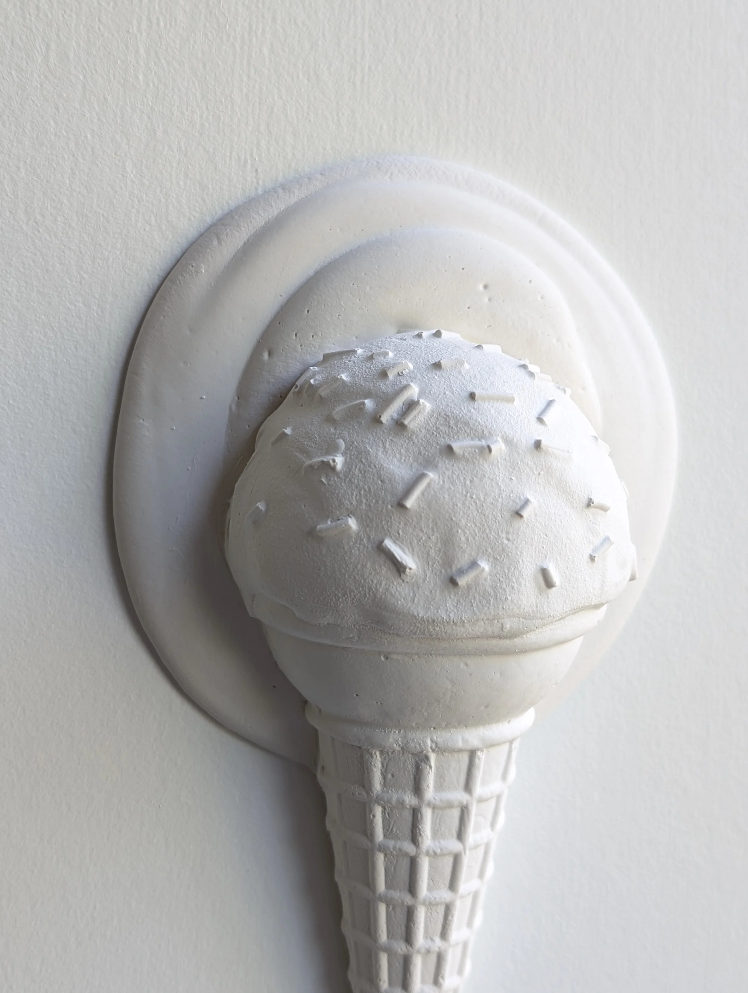 Close-up view of sculptural detail on an ice cream wall artwork