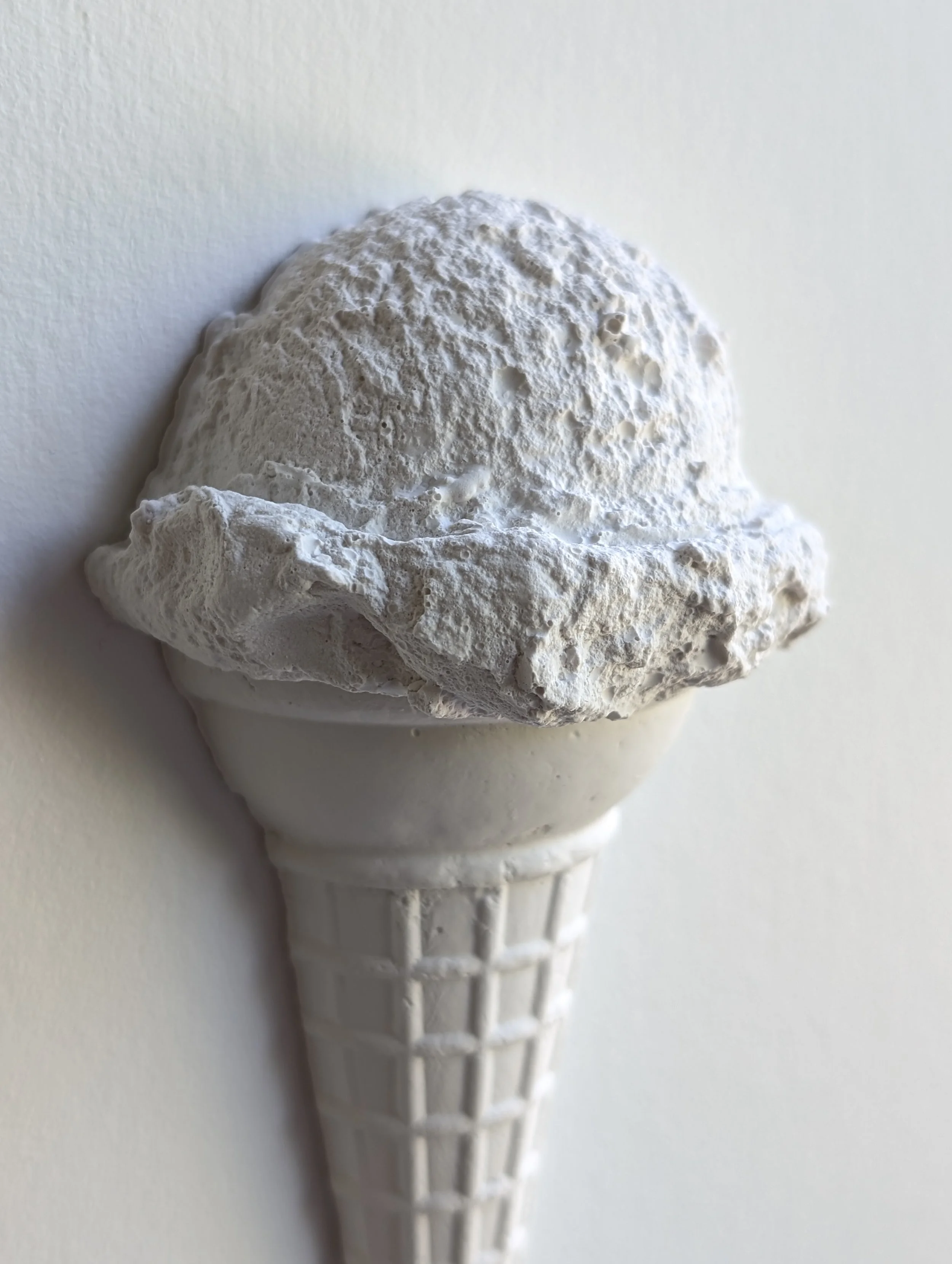 Details of wall-mounted ice cream sculpture, showcasing highlights and shadows of the hydrocal plaster