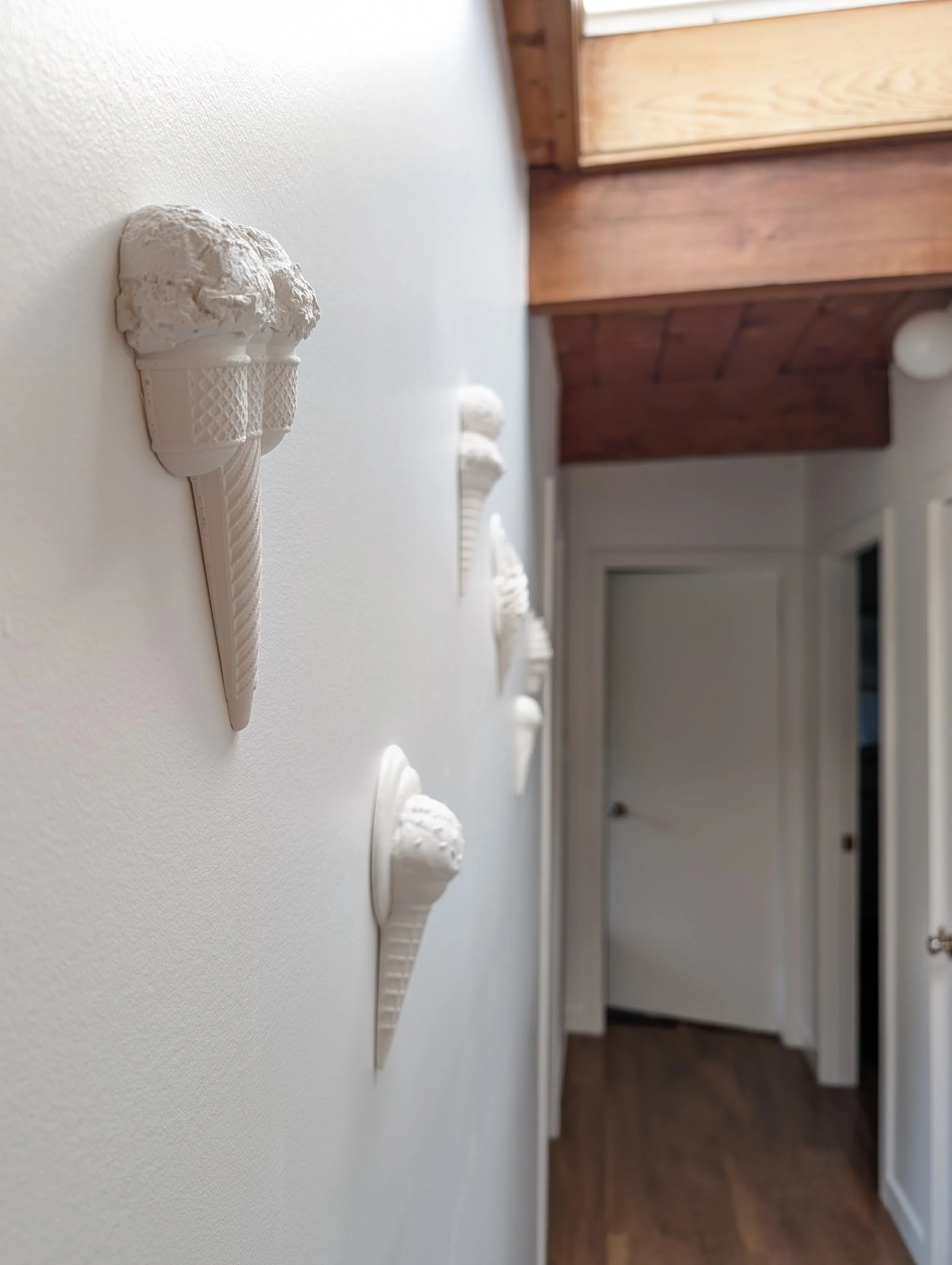 Photograph of white sculpture wall artwork displayed in a minimalist home in Vancouver, BC