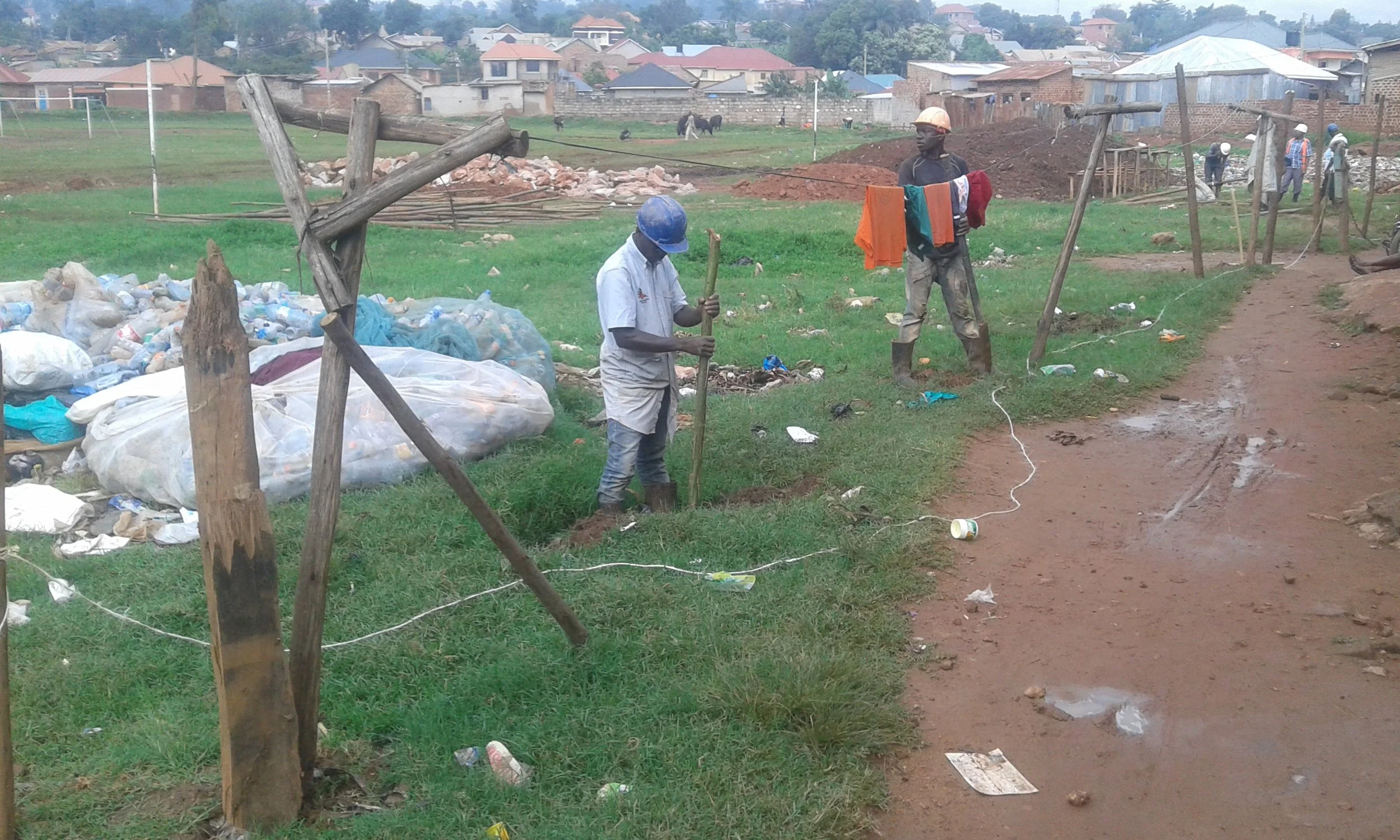 Community members work to clean up garbage and build a safe walkway. Credit: UN-Habitat