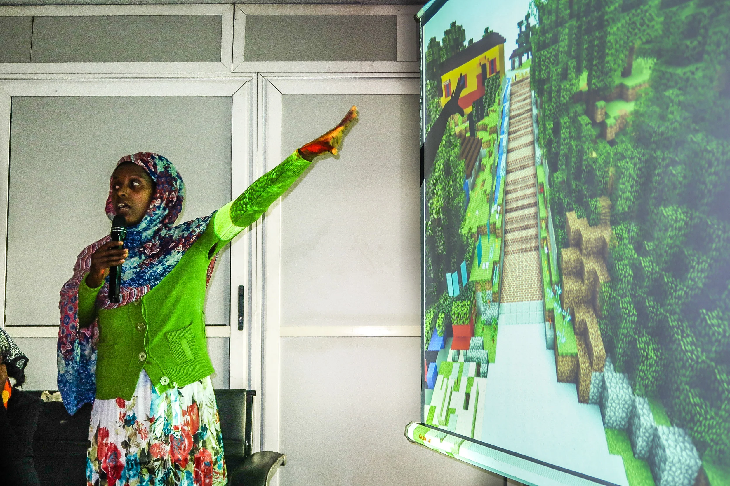 A young woman shares her design proposal for the site. Credit: UN-Habitat